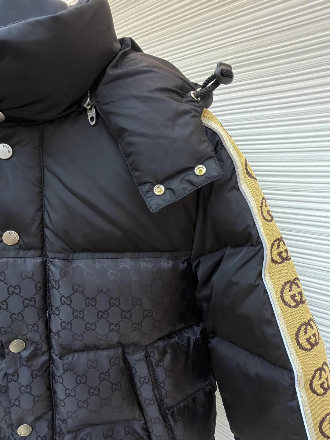 Gucci full-print webbing nylon down jacket ●Original version: purchased and developed by 10929 ●Item number: 1681831-C85 ●Fabric: goose down fabric ●Technology: mechanical down filling ●Color: black ●Version: fitted version ●Weight: about 1120 grams ●Size: 42-44-46-48-50 ●Description: This Gucci patchwork down jacket uses collision splicing technology: the body is made of high-density matte nylon, embossed with the brand's classic double G dark pattern, and heat-pressed shaping technology is used to ensure the three-dimensionality of the pattern; the shoulders and sleeves are made of glossy nylon fabric, with side webbing (full-print Double G logo). The webbing is connected to the body through precision sewing technology, and the edges are neatly seamed. It uses segmented down filling quilting to accurately control the amount of down filling according to areas, taking into account both warmth and style. The hood is designed with a metal adjustment buckle, the placket is closed with a metal snap button, and the cuffs and hem are elastic ribbed. The overall design is 3D cut, and the material contrast in the details echoes the logo, which not only retains brand recognition, but also enhances the comfort and functionality of wearing. The overall wiring is straight and delicate, the fabric is comfortable and soft, and the color is consistent without color difference. It can be matched with the same style to create a fashionable look and control various occasions. Customized accessories, complete with three standards, same style for men and women!