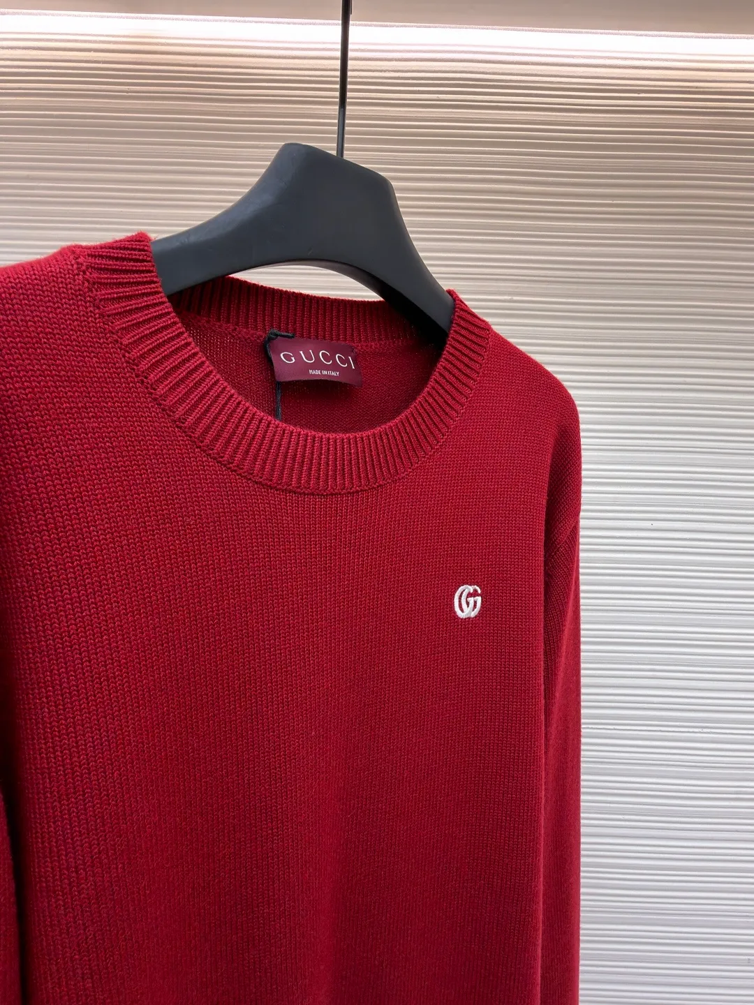 Gucci Double G embroidered knitted sweater ●Item number: 1682190-A85 ●Material: wool fabric ●Technology: knitted production ●Color: red ●Version: fitted version ●Weight: about 765 grams ●Size: S-M-L-XL ●Description: The fabric is made of high-count merino wool yarn. After combing to remove impurities, it is woven with a 12-pin circular knitting machine to create a waffle texture. The texture is even and soft to the touch. The yarn is first pre-dyed and fixed to ensure a full red tone and is not easy to fade. The neckline, cuffs and hem are designed with ribbed edges. The ribbing structure is a 1*1 elastic structure. It has been treated with high-temperature shaping technology and has good resilience and is not easy to loosen and deform. The Double G logo on the left chest is embroidered by hand, using fine wool threads of the same color and sewn with flat embroidery stitches. The stitches are fine and flat, and the outline of the logo is precise and symmetrical. The splicing of the body adopts embedded clip technology, and the seams are smooth without bulges. The shoulders are three-dimensional cut-outs, which are in line with the ergonomic design. Each piece is cut by laser positioning, and the size error is controlled within 0.3cm. The overall sewing has undergone multiple quality control inspections, from yarn weaving to final product shaping. The brand's strict process standards are followed throughout the process to create knitted items with both texture and wearing comfort. The overall wiring is straight and delicate, the fabric is comfortable and soft, and the color is consistent without color difference. It can be matched with the same style to create a fashionable look and control various occasions. Customized accessories, complete with three standards, same style for men and women!