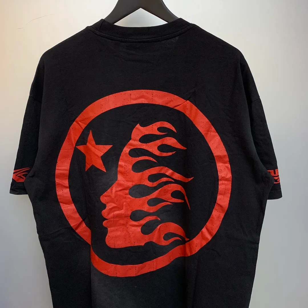 P134 Hellstar Beat Us! T-Shirt Custom Cut and sew garment manufactured in Los Angeles. Dyed and potassium sprayed with jumbo screen print. Fits slightly oversized. Gentle wash tumble dry. Dry clean preferred Newly popular Hellstar short-sleeved T-shirt!   Standard beauty and trendy workmanship, original customization (fabric, pattern, printing, hang tag, main mark, etc.), exaggerated style, explosive style, dare to break through tradition, bring adventurous new fashion experience!  YoungBoy, the most popular rapper in the youth circle, has shot a lot of models for him, and celebrities such as Dababy and Swae Lee frequently get dressed!  color: Vintage Black (washed black)