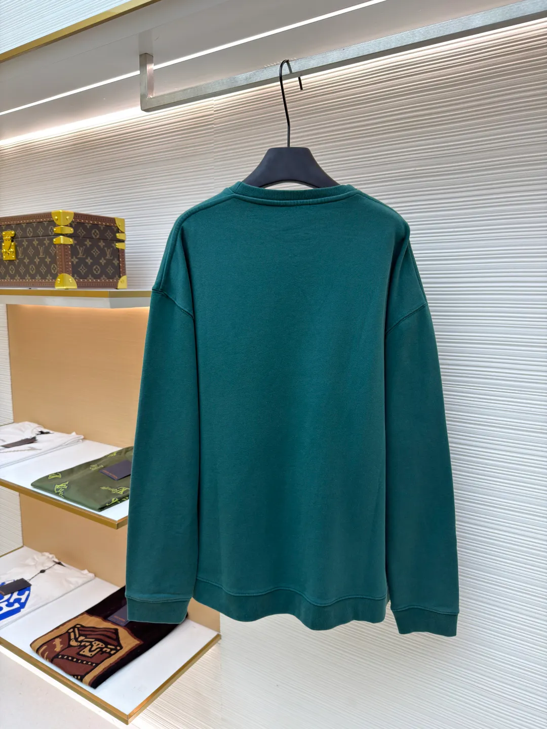 Loewe zigzag thread appliqué round neck sweatshirt ●Original version: Purchased and developed by 3621 ●Item number: 1680967-A90 ●Fabric: Fleece fabric ●Technology: Laser cutting appliqué production ●Version: Fitted version ●Weight: about 635g ●Size: 2*2 thread, 470g. The fish scale bottom fabric forms a fish scale pattern through a specific weaving process, and the plates are arranged and interwoven according to the warp and weft patterns and shapes to ensure clear texture and excellent texture. The fabric has been carefully produced and processed, and has good durability, lightness, softness, and good breathability. The edge-strengthened branches of the appliqué embroidery add a rough industrial look by imitating zigzag-shaped stitches. The appliqué stitches are in the form of trapezoidal zigzags, resembling interlaced canine teeth; emphasizing high stitch density and sharp turns, like saw blade cutting marks. Trim the seam allowance and cut off excess fabric along the dogtooth stitches to retain the jagged three-dimensional effect. After the garment is made, it is made through frying process. The garment is dyed, washed and aged using new environmentally friendly technology. Fabrics are dyed using a stone grinding method, and the garments are continuously immersed in dye and tumbled. After frying the sand, the fabric fades slightly, changing the color of the original fabric to show a nostalgic color with different shades of light and dark. The neckline adopts a structural feature formed by a V-shaped rib weaving method, which visually has a unique sense of line and extensibility. The rib structure itself has good elasticity and stretchability; inserts are added to the shoulder seams to increase the service life. The neckline, hem, and cuffs are all spliced ​​with double-needle threading. The body and sleeves are structurally split and quilted. The fabric material has high ductility and no sense of restraint. The overall wiring is straight and delicate, the fabric is comfortable and soft, and the color is consistent without color difference. It can be matched with the same style to create a fashionable look and control various occasions. Customized accessories, complete with three standards, same style for men and women!
