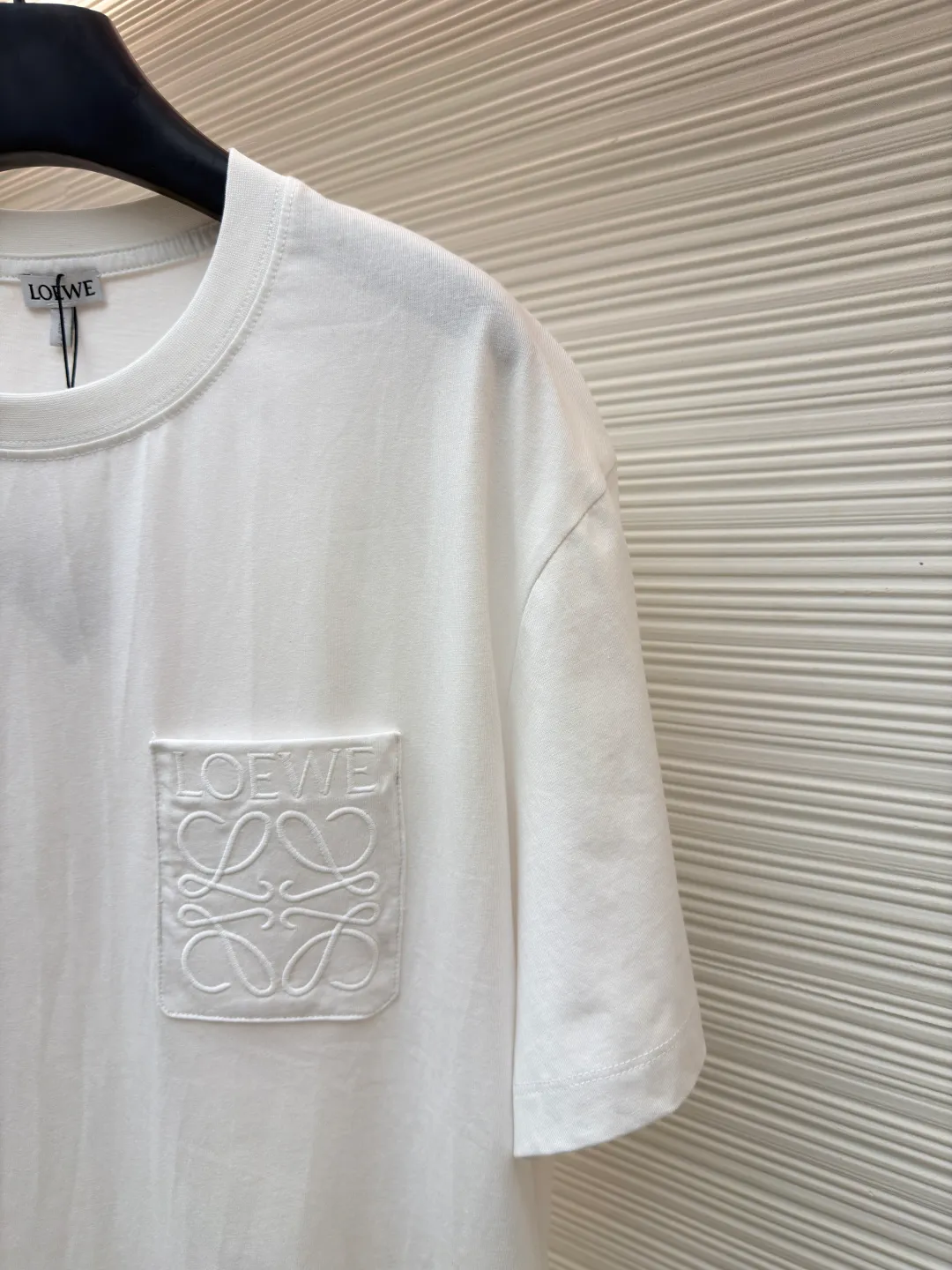Loewe Anagram pocket embroidered short sleeves ●Original version: 4800 purchase and development ●Item number: 1682457-X90 ●Material: precision super soft brocade cotton fabric ●Technology: embroidery production ●Color: white ●Version: fitted version ●Weight: about 245 grams ●Size: S-M-L-XL ●Description: Customized satin precision super soft brocade cotton, delicate and soft, comfortable and close to the skin, decorated with LOEWE Anagram embroidered pockets on the chest The pocket design cleverly integrates the essence of the brand, shining like a work of art. The pocket style exudes unique charm, simple yet stylish. Adopt imported machine embroidery technology, use advanced computer control systems and precision mechanical components to achieve Anagram embroidery operations with high precision. The lines are smooth and delicate, and the fabrics have been washed. It has a better hand feel and texture, is not easy to deform, is not easy to shrink, is not easy to fade, and maintains long-term beauty. The overall wiring is straight and delicate, the fabric is comfortable and soft, and the color is consistent without color difference. It can be matched with the same style to create a fashionable look and control various occasions. Customized accessories, complete with three standards, same style for men and women!