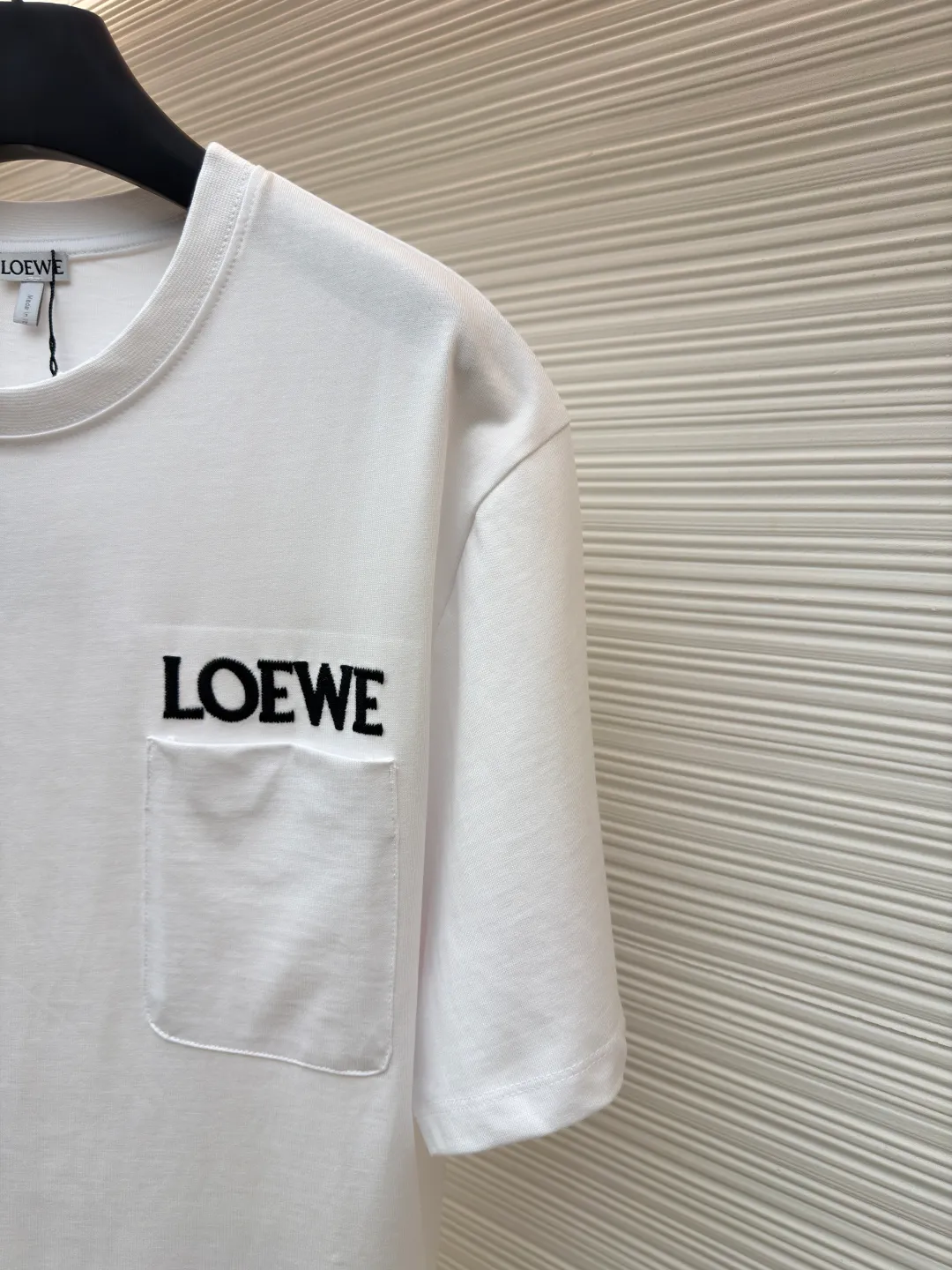 Loewe Patch Pocket Round Neck Short Sleeve ●Original version: Purchased and developed in 3010 ●Item number: 1681854-A00 ●Material: combed cotton fabric ●Technology: embroidery production ●Color: white ●Version: fitted version ●Weight: about 275 grams ●Size: XS-S-M-L ●Description: Made of 15S fine cotton plain fabric, 230g; with 32S double yarn thread, 300g. Plain weave fabric made from combed cotton fibers has a more orderly arrangement and higher density than ordinary cotton, so it has better texture and luster. 15S fine cotton plain fabric is a high-quality cotton fabric with the characteristics of softness, comfort, good breathability, and good durability. Matching the specific color and thick thread material, single-needle lock embroidery is mainly used, and the stitches of this embroidery are fine. The craftsmanship is exquisite. The edge of the pattern not only makes the embroidery appear smooth, but also the stitches are arranged neatly and evenly, without exposing the ground or overlapping. The embroidery uses thick lines to outline the letter pattern, and the thick lines create a more three-dimensional texture. Thick thread embroidery has the rough feel of hand embroidery, and the overall effect is three-dimensional and the texture is delicate, creating a dual texture in terms of look and feel. The overall wiring is straight and delicate, the fabric is comfortable and soft, and the color is consistent without color difference. It can be matched with the same style to create a fashionable look and control various occasions. Customized accessories, complete with three standards, same style for men and women!
