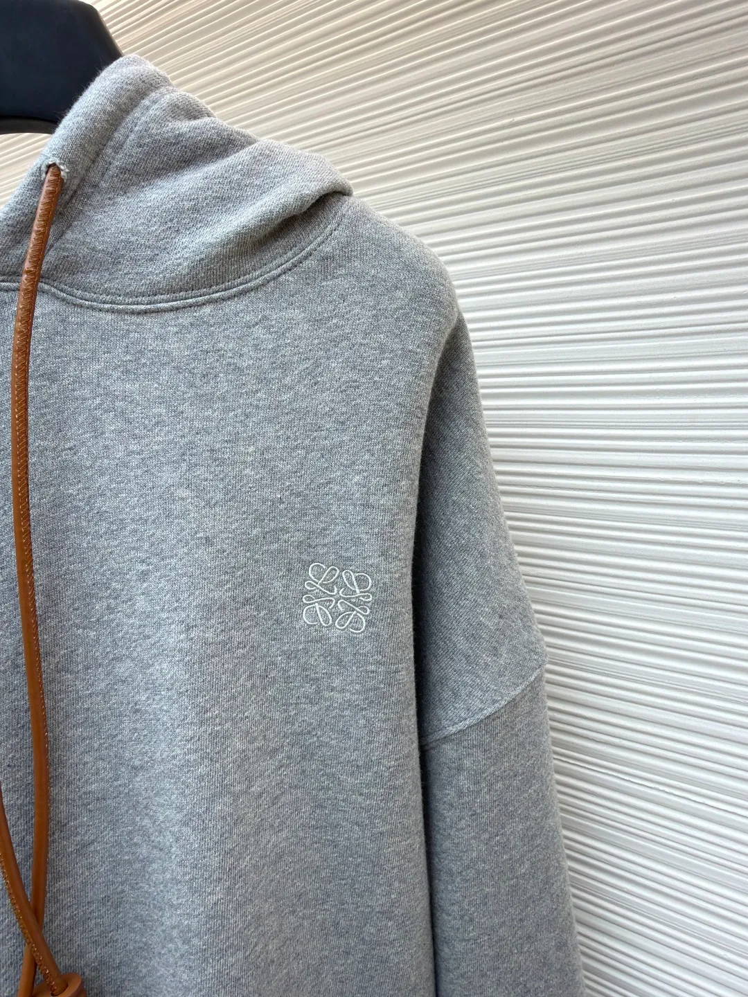 Loewe Anagram leather embroidered hooded sweatshirt ●Original version: Purchased and developed for 8800 ●Item number: 1682380-A70 ●Material: cotton fabric ●Technology: embroidery production ●Color: gray ●Version: Fitted version ●Weight: about 815 grams ●Size: S-M-L-XL ●Description: Customized medium-weight looped cotton velvet fabric, soft and comfortable to the touch, wide and stylish, with pure black as the background color It outlines a simple but not simple outline. The iconic Loewe Anagram embroidery is embellished on the chest. It is paired with a Flamenco-style leather drawstring to inject a touch of unique style. It is low-key but highlights the taste. Simplify it and mix it casually to release your individual style. It adopts imported machine embroidery technology and uses advanced computer control systems and precision mechanical components to achieve Loewe Anagram embroidery operations with high precision and smooth and delicate lines. The fabrics have been washed to give them a better feel and texture. They are not easy to deform, shrink or fade, and maintain their long-lasting beauty. The overall wiring is straight and delicate, the fabric is comfortable and soft, and the color is consistent without color difference. It can be matched with the same style to create a fashionable look and control various occasions. Customized accessories, complete with three standards, same style for men and women!