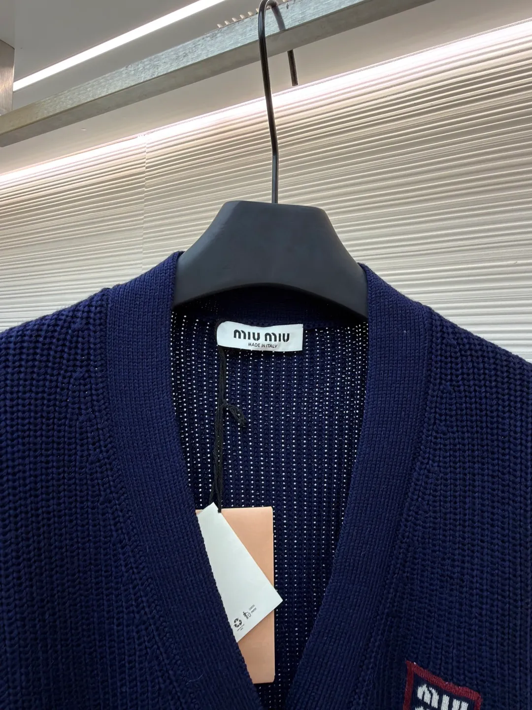 MIUMIU College Style Chest Logo Jacquard Sweater ●Original version: Purchased and developed for 26900 ●Item number: 1681494-A65 ●Fabric: wool blended fabric ●Technology: Knitted ●Color: off-white/navy blue ●Version: Fitted version ●Weight: about 785g ●Size: 42-44-46 ●Description: Made of 40% sheep soft 15% wool 45% cotton blended fabric, original dyed royal blue. Use 7 stitches to knit a multi-piece sewing plate. It uses horn buttons, each button has irregular horn patterns, and the chest label is made of pure cotton custom jacquard MiuMiu. Tennis-inspired details accent this cashmere and wool-blend cardigan. The distinctive ribbed pattern and oversized shape create a casual and elegant style. The overall wiring is straight and delicate, the fabric is comfortable and soft, and the color is consistent without color difference. It can be matched with the same style to create a fashionable look and control various occasions. Customized accessories, complete with three standards, same style for men and women!