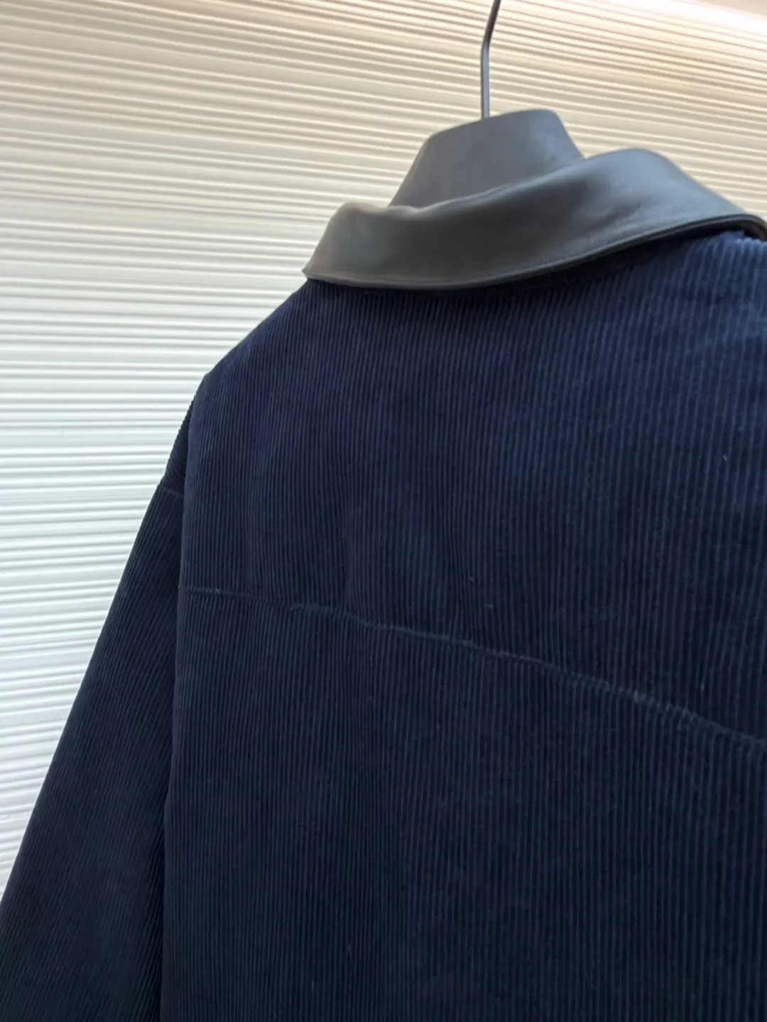 MIUMIU leather collar corduroy down jacket ●Original version: purchased and developed by 16097 ●Item number: 1681743-C75 ●Fabric: corduroy fabric ●Technology: patch embroidery production ●Color: navy blue ●Version: fitted version ●Weight: about 935 grams ●Size: 46-48-50-52 ●Description: When embroidery of the same color quietly grows among the corduroy textures - MIUMIU redefines winter elegance with "hidden beauty", making warmth a tacit whisper. Classic fine-ribbed corduroy wraps the body, with down like clouds lurking between the convex and convex warps and wefts. 90% white duck down silently resists the cold wind, but lets the fabric speak for itself - every velvet is the path of sunlight, and every ridge is a fortress built by warmth. The custom-made lambskin lapel falls along the curve of the neck, making it breathable like a second skin. Cold leather and soft suede complete a material game on the collar, and the sound of metal snaps opening and closing becomes the only punctuation mark in this dialogue. Exquisite appliqué technology performs visual magic on the left breast pocket: the embroidered letter patches are laser cut and shaped to create an embossed texture and clear fonts. Each patch undergoes 5 layers of anti-wrinkle treatment to ensure that it retains its original shape after washing. The embroidered fabric of the same color as the fabric runs along the MIUMIU logo, with only subtle gloss differences and raised stitches to enhance visual recognition. The overall wiring is straight and delicate, the fabric is comfortable and soft, and the color is consistent without color difference. It can be matched with the same style to create a fashionable look and control various occasions. Customized accessories, complete with three standards, same style for men and women!