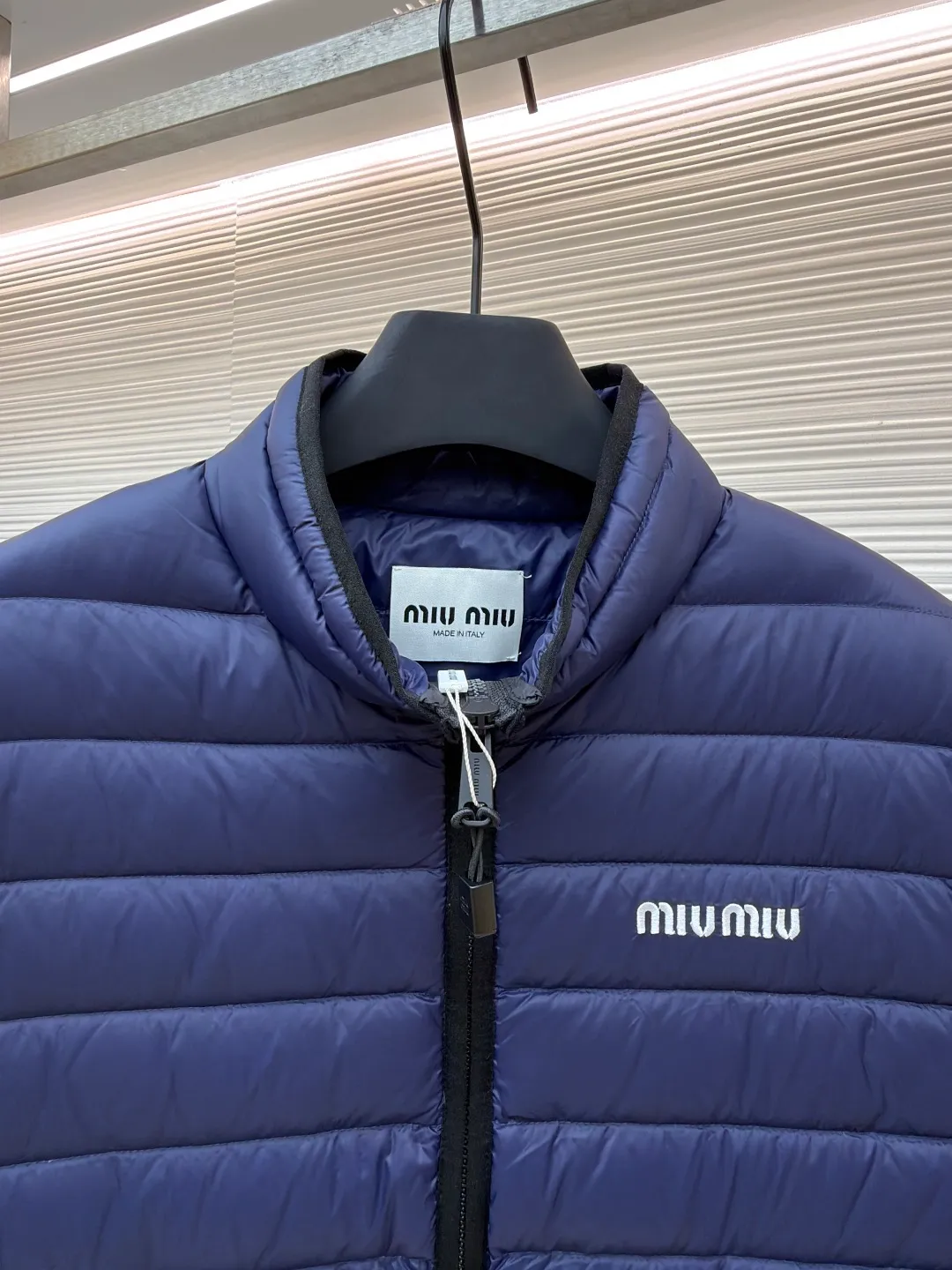 MIUMIU embroidered down vest ●Original version: purchased and developed by 15870 ●Item number: 1681121-B70 ●Fabric: high-quality down fabric ●Technology: embroidery production ●Version: fitted version ●Weight: about 380 grams ●Size: 34-36-38 ●Description: High-end nylon fabric made of high-count polyamide fiber, known for its excellent tensile strength and wear resistance. Its good flexibility makes the fabric less prone to wrinkles and keeps it crisp and stylish for a long time. The tight weave effectively blocks the invasion of cold wind and locks in the warm air generated by the down layer. The high-density nylon surface forms a certain lotus leaf effect, making it difficult for small water droplets to penetrate, keeping the interior dry and effectively extending the service life of the down. It uses 90 national standard high-quality down, with a filling capacity of 140 grams. It has high fluffiness, strong warmth retention, lightness and no burden, and can easily cope with cold weather. Whether it is urban commuting or outdoor leisure, this down jacket has become an indispensable luxury item in the winter wardrobe with its excellent performance and simple design. The logo adopts imported machine embroidery technology, uses advanced computer control systems and precision mechanical components to achieve mimiu embroidery operations, with high precision, smooth and delicate lines. The overall wiring is straight and delicate, the fabric is comfortable and soft, and the color is consistent without color difference. It can be matched with the same style to create a fashionable look and control various occasions. Customized accessories, complete with three standards, same style for men and women!