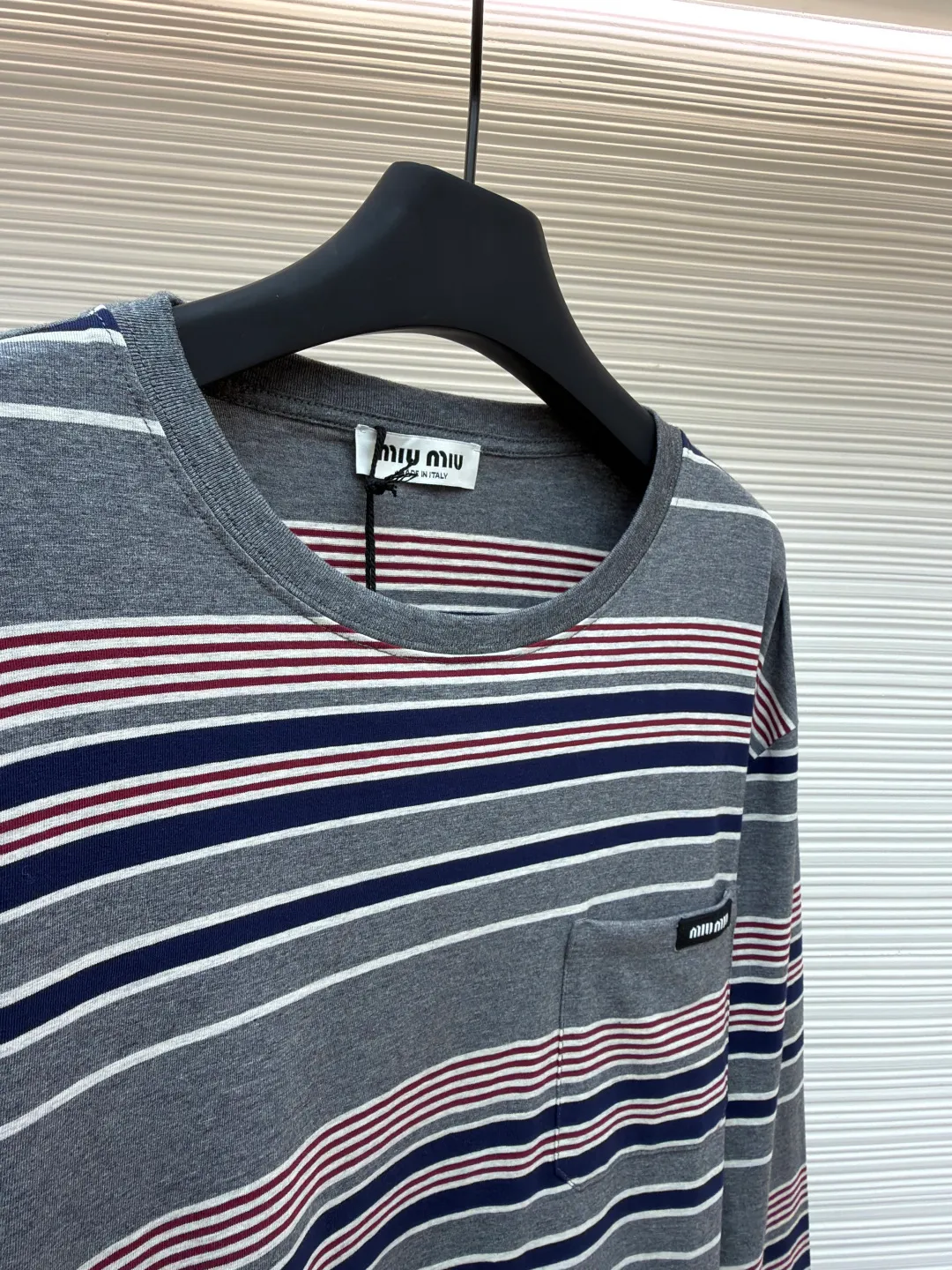 MIUMIU red, white and gray striped round neck long sleeves ●Original version: Purchased and developed for 6999 ●Item number: 1681640-A15 ●Fabric: Jacquard striped knitted fabric ●Technology: Woolen production ●Color: red, white and gray ●Version: Fitted version ●Weight: about 265 grams ●Size: S-M-L-XL ●Description: Using 24S jacquard stripe technology special textile compact cotton , 185g; with 32S double yarn frame, 380g. The fabric is made of 24-count combed cotton yarn and processed through a compact spinning process, which makes the yarn fibers tightly arranged and significantly reduces impurities and hairiness. The fabric structure is denser and smoother. It not only feels delicate and smooth, but its wear resistance and anti-pilling properties are also far superior to ordinary cotton fabrics. The weight of the fabric ensures that the fabric has good durability while maintaining the natural breathability and skin-friendly properties of cotton. It is very suitable for spring, summer and transitional seasons, and achieves the unity of comfort and quality. The striped effect is achieved through plain knitting technology where colored yarns are alternately woven. This is different from later printing. The color is firm and long-lasting, and the striped edges are clear and neat. The design that combines simple stripes with the possible jacquard texture of the underlying fabric increases the visual layering, avoids monotony, and embodies the design idea of ​​finding sophistication in simplicity. The overall wiring is straight and delicate, the fabric is comfortable and soft, and the color is consistent without color difference. It can be matched with the same style to create a fashionable look and control various occasions. Customized accessories, complete with three standards, same style for men and women!
