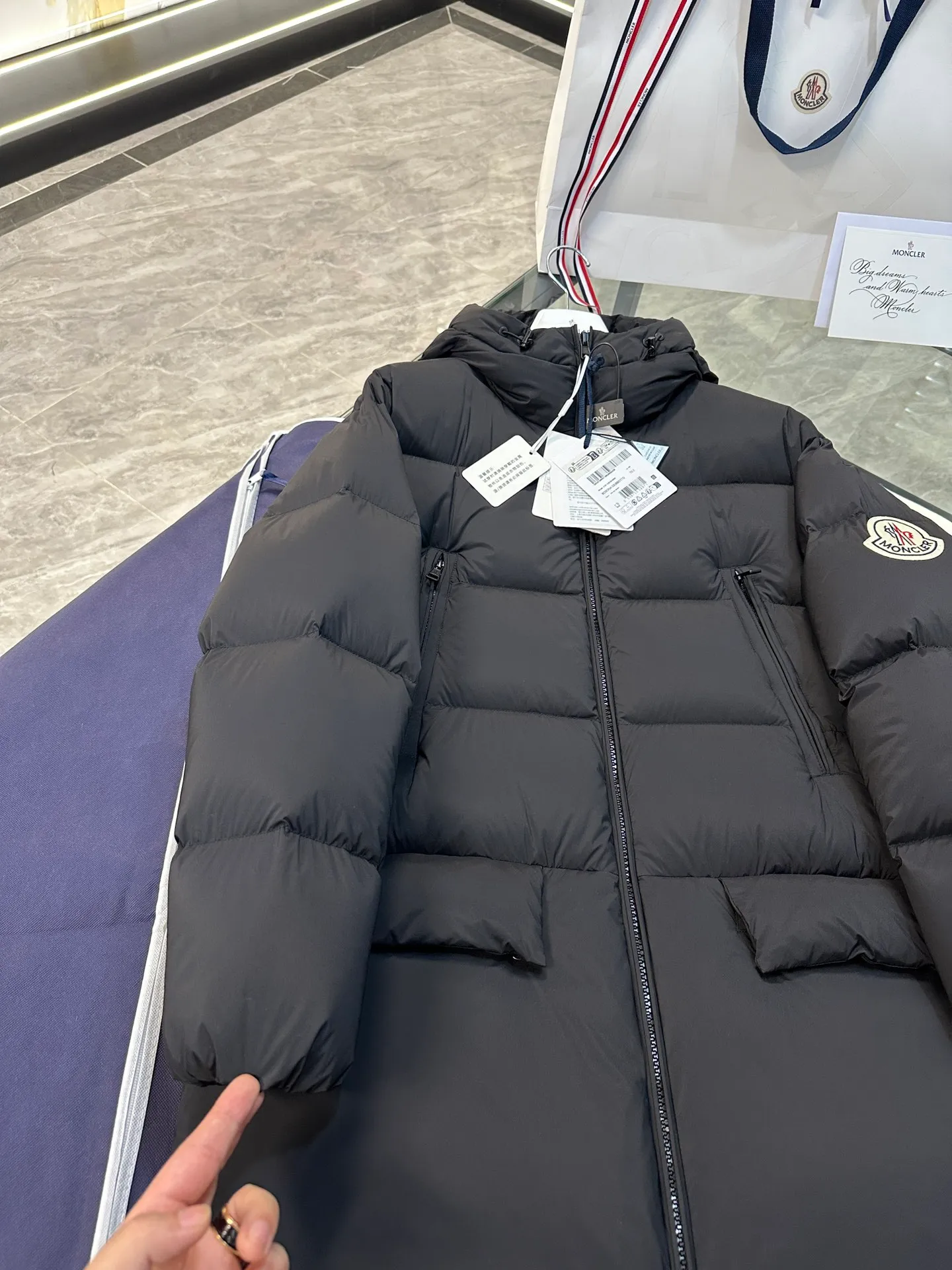 P1120 Moncler Bosona mid-length large felt badge down jacket. More details shot.