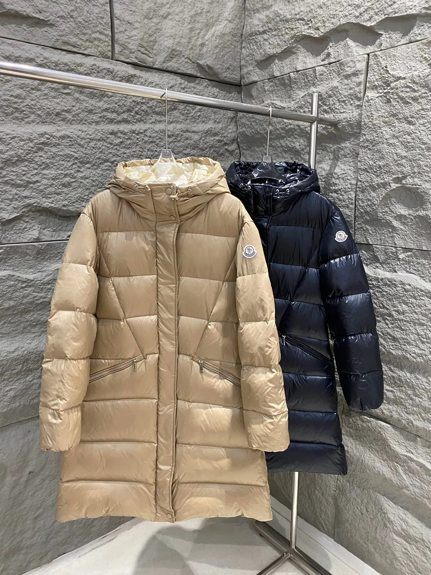 P1060 Moncler's new Bellevue women's long belted down jacket. The Bellevue down jacket is made of iconic nylon laqué fabric, interpreting classic Moncler style. Long design, the fabric has been functionally treated for a gorgeous lustrous effect. This hooded thermal piece has a feminine silhouette and an elastic waistband. From day to night, from the city to the mountains, it can be easily handled. Color: Black/Camel Beige Size: 0/1/2/3