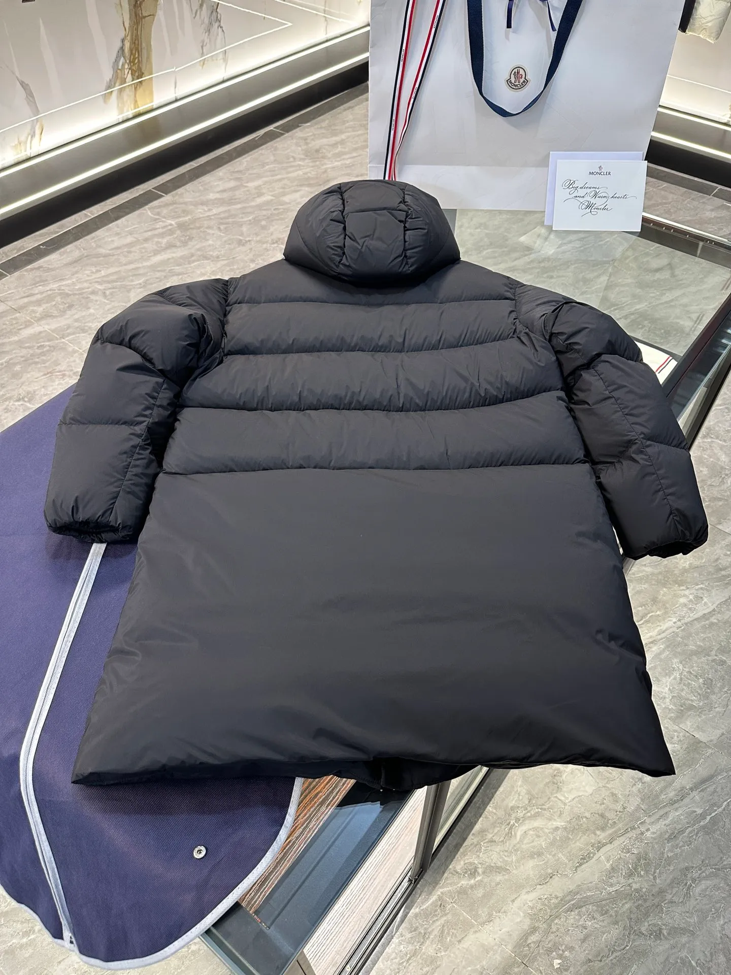 P880 Moncler Bosona mid-length large felt badge down jacket. More details shot.