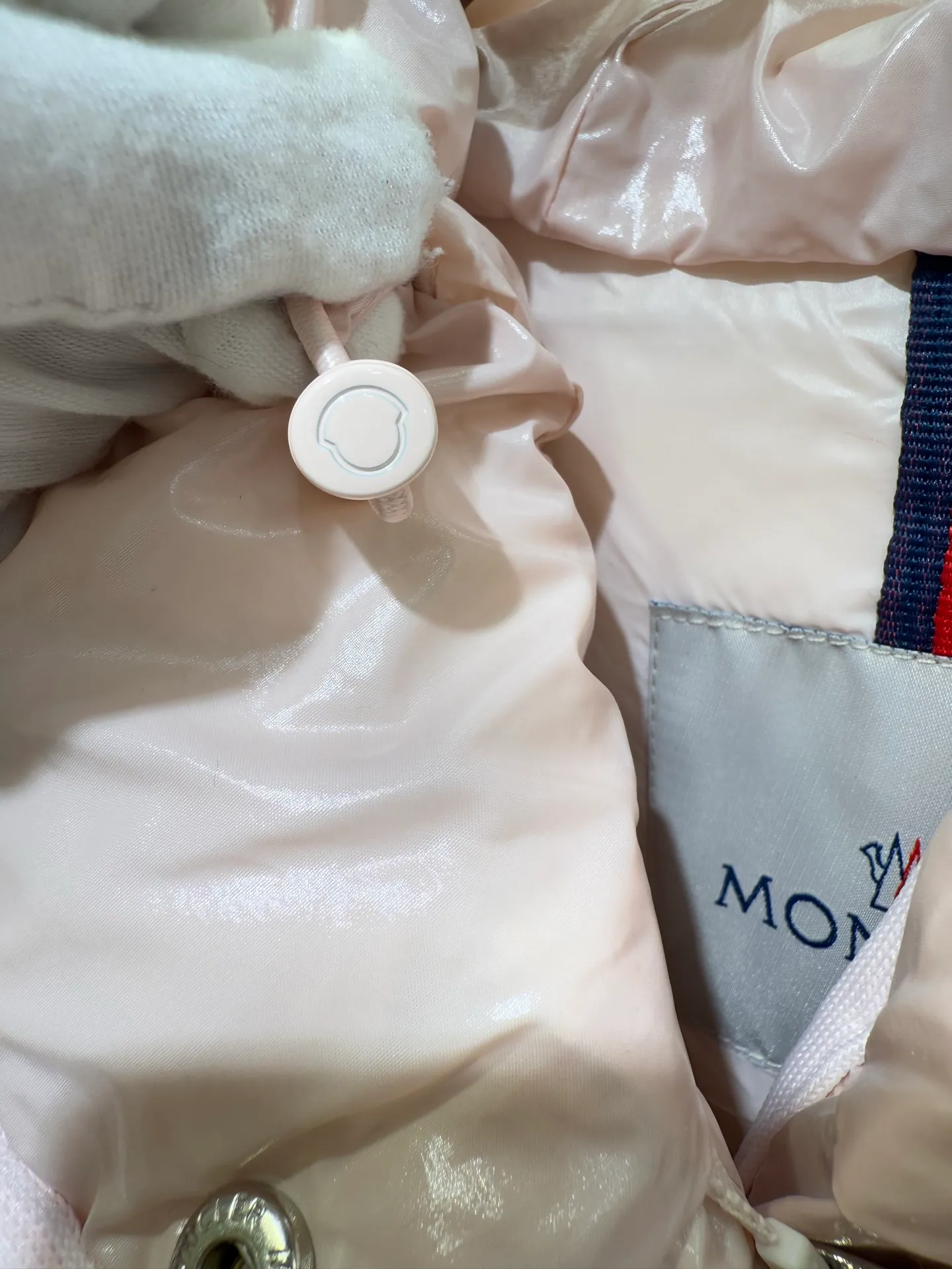 P1140 Moncler Barante series short waisted down jacket. The Barante down jacket is made of glossy nylon fabric and is inspired by the 1970s. The short version features a nipped-in waist and an A-line silhouette, highlighting a feminine style. An adjustable hood and signature logo patch add finishing touches.  Fabric: Made of nylon laque fabric, Nylon laque lining, filled with down (90 white goose down) Craftsmanship: Adjustable hood, zipper and snap closure, zipper pocket Adjustable cuffs (supports NFC function Color: black pink off-white Size: 0 1 2 3 4446080