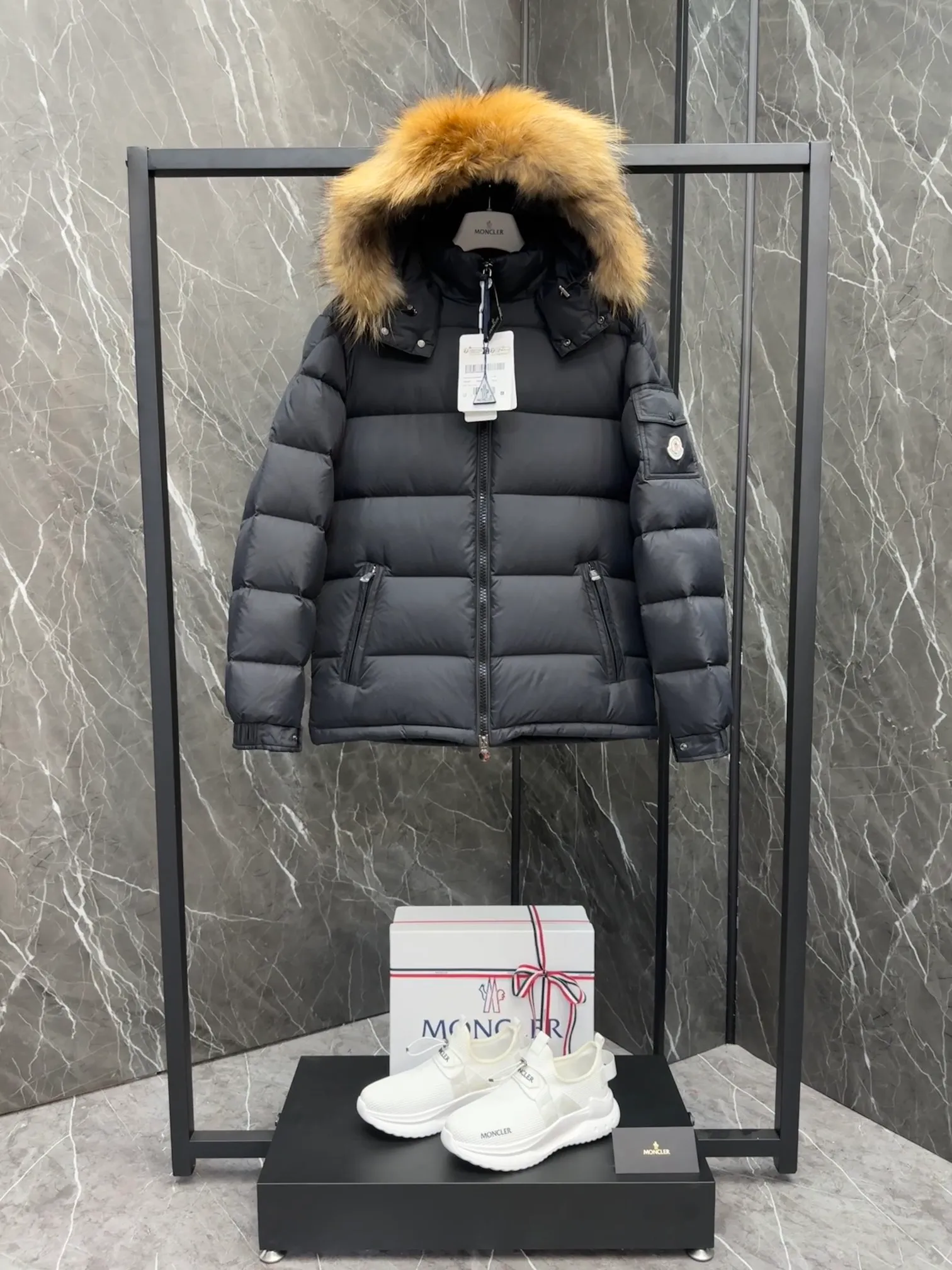 P1040 ⬆️Moncler Mayaf short men's down jacket. The hood is removable. The fur collar is removable. Based on Maya, a removable fur collar is added. The Mayaf men's hooded down jacket is made of functional nylon fabric, and the hood is equipped with removable synthetic material trim.  The Mayaf short down jacket is a reinterpretation of the classic Moncler Maya style in an instantly recognizable silhouette, with a removable hood and adjustable hem. Made from functional fabric with removable synthetic trim on the hood. The sleeves are embellished with classic patch pockets, reflecting the brand's signature style. Details •Made from functional fabric •Technical fabric lining •Down-filled •Push-stud collar •Detachable hood with removable synthetic trim •Zip closure •Zip pockets •Patch pockets with press-stud •Adjustable elastic cuffs •Adjustable drawstring hem