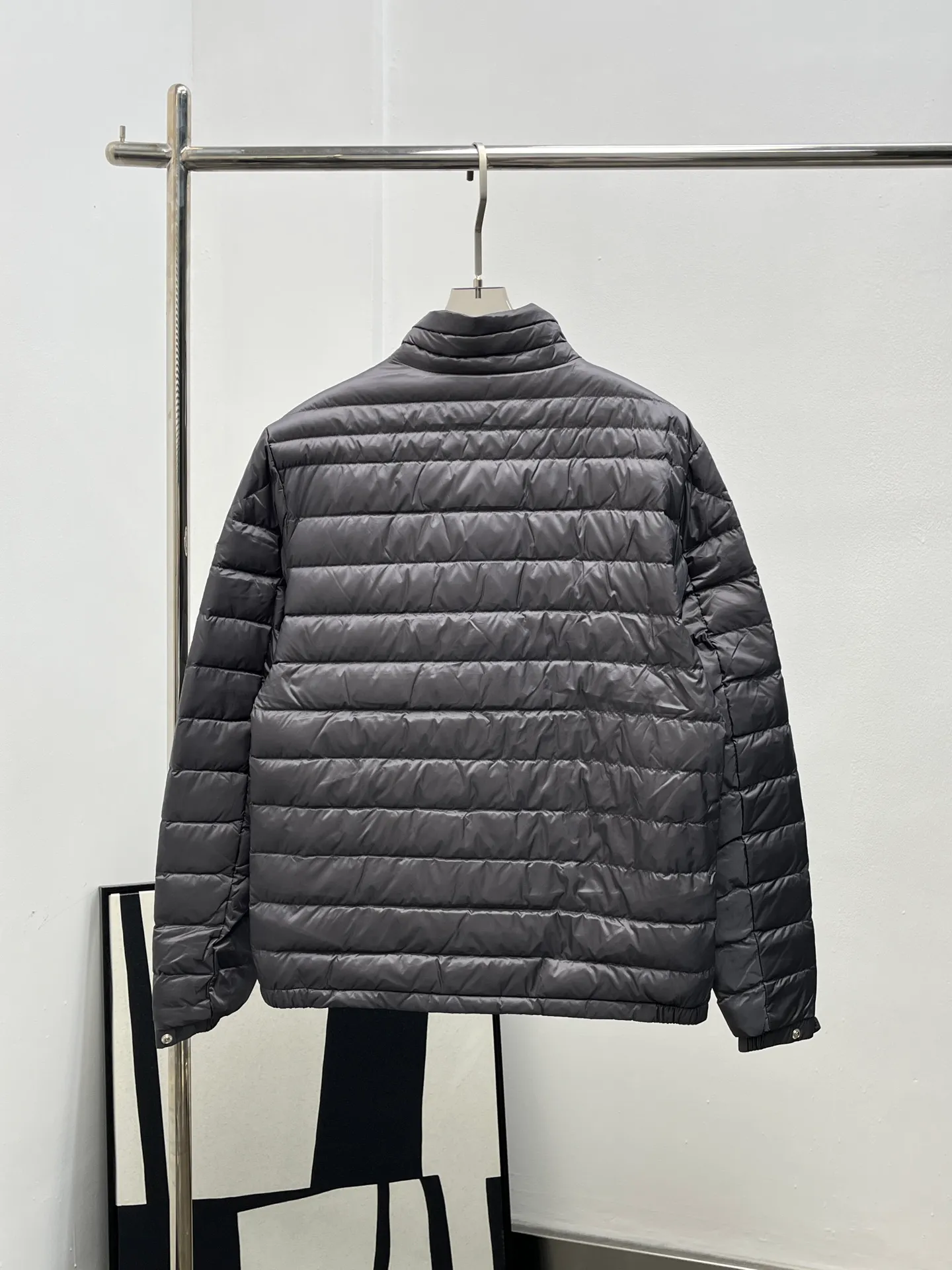 P920 25Moncler *Arnique men's short down is light and thin. Arnique short down is light and warm and made of longue saison fabric. This functional nylon fabric provides warmth without being bulky. This style is finished with quilting in varying sized squares, which helps give it a lightweight texture. The classic fit design can be easily paired with urban casual wear or as sports wear for outdoor activities. Color: black gray