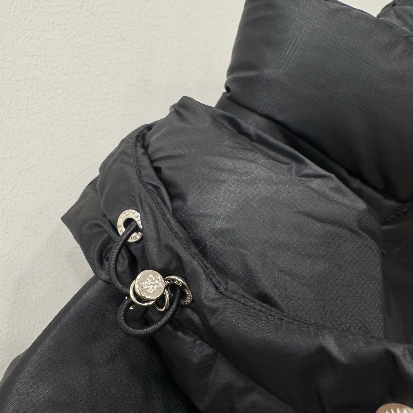 P1100 Brand: Moncler Filling: 90 white duck down Weight: 380-450 Color: White Black Gray Size: 12345 [Couyere Men's Hooded Short Down Jacket] The Couyere short down jacket is durable and practical, provides functional warmth and care, and will accompany you to meet challenges.  The Couyere is a durable down jacket made from a fine fabric that's durable and functional, with velvet resistance and functionality. The short design creates a sculpted silhouette, and padded pockets add a modern feel. The sleeves are embellished with signature patch pockets, a nod to the classic Moncler Maya down jacket.  • Made of fine ripstop fabric • Fine fabric lining • Down filling • Detachable and adjustable hood • Zip closure • Zippered pockets • Press-studs on sleeve pockets • Elastic cuffs • Drawstring hem Fabric: 100% nylon; Lining: 100% nylon; Filling: Goose down Down content: 90%; except upholstery; Maximum wash temperature 30°C - Mild wash; Do not bleach; Do not tumble dry; Ironing maximum temperature 110°C - without steam; Hydrocarbon dry cleaning - gentle wash; Professional wet cleaning - gentle wash; Lay flat to dry in shade; Wash separately; Remove removable accessories before washing; Recommend washing and ironing inside out