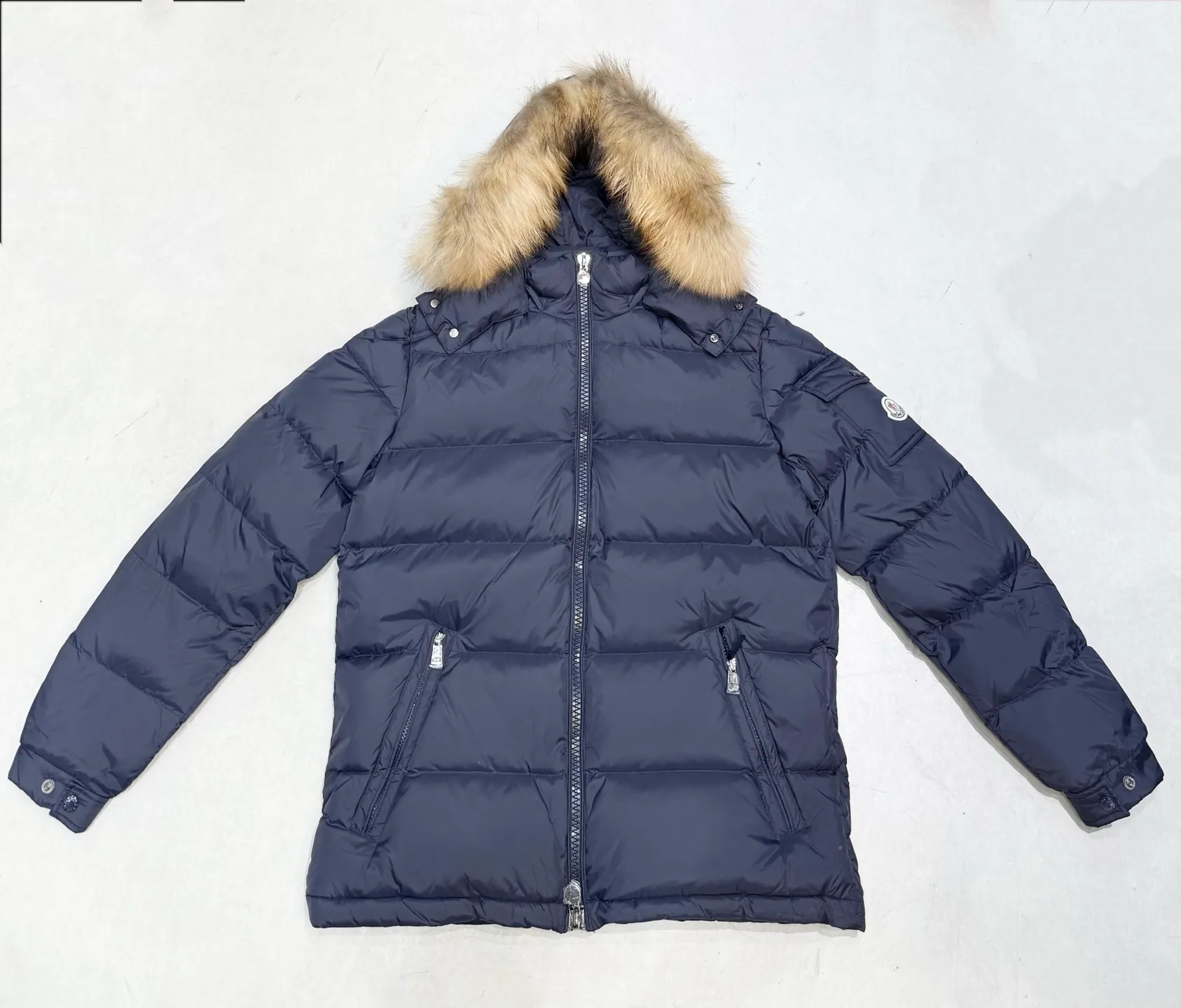 P1040 Men's Moncler Mayaf short men's down jacket. The hood is removable and the fur collar is removable. Based on Maya, a removable fur collar is added. The Mayaf men's hooded down jacket is made of functional nylon fabric, and the hood is equipped with removable synthetic material trim. The Mayaf short down jacket is a reinterpretation of the classic Moncler Maya style in an instantly recognizable silhouette, with a removable hood and adjustable hem. Made from functional fabric with removable synthetic trim on the hood. The sleeves are embellished with classic patch pockets, reflecting the brand's signature style. Details •Made from functional fabric •Technical fabric lining •Down-filled •Snap-stud collar •Detachable hood with removable synthetic trim •Zip closure •Zip pockets •Patch pockets with press-stud •Adjustable elastic cuffs •Adjustable drawstring hem Size : 1-5
