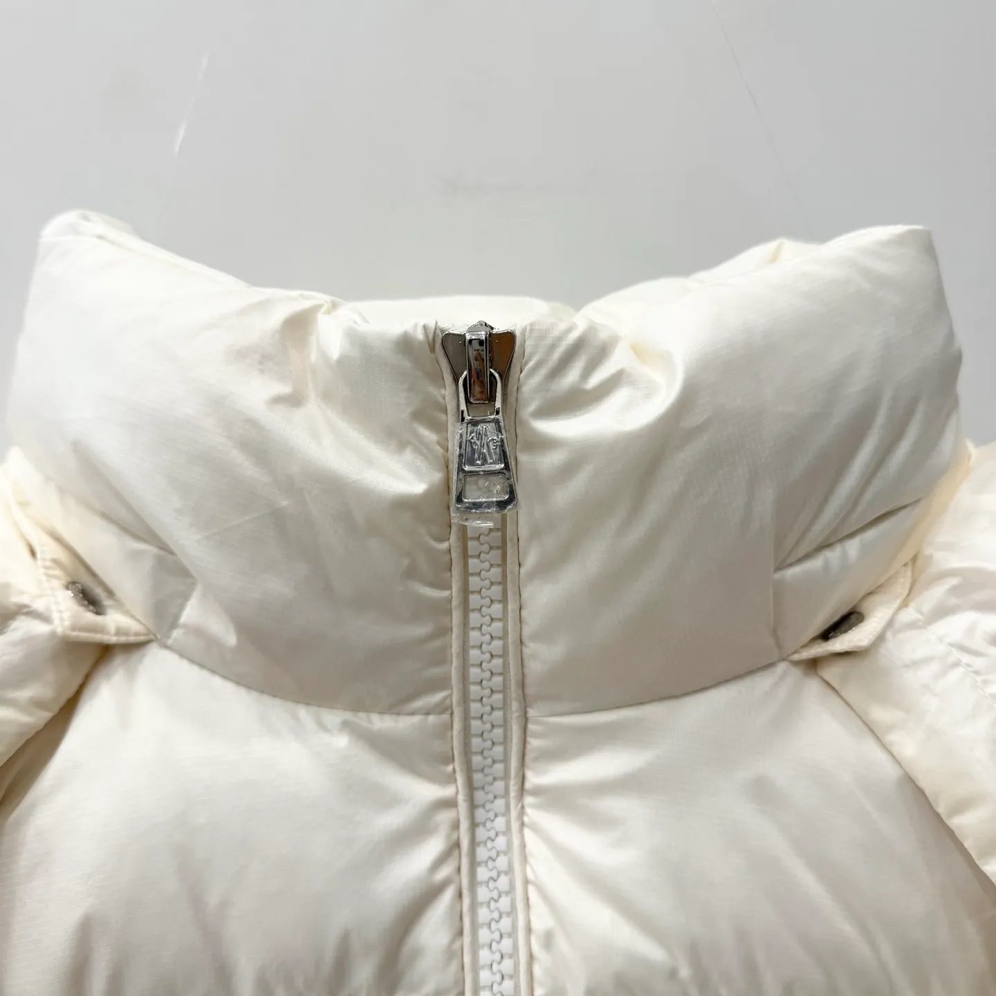 P1100 Brand: Moncler Filling: 90 white duck down Weight: 380-450 Color: White Black Gray Size: 12345 [Couyere Men's Hooded Short Down Jacket] The Couyere short down jacket is durable and practical, provides functional warmth and care, and will accompany you to meet challenges.  The Couyere is a durable down jacket made from a fine fabric that's durable and functional, with velvet resistance and functionality. The short design creates a sculpted silhouette, and padded pockets add a modern feel. The sleeves are embellished with signature patch pockets, a nod to the classic Moncler Maya down jacket.  • Made of fine ripstop fabric • Fine fabric lining • Down filling • Detachable and adjustable hood • Zip closure • Zippered pockets • Press-studs on sleeve pockets • Elastic cuffs • Drawstring hem Fabric: 100% nylon; Lining: 100% nylon; Filling: Goose down Down content: 90%; except upholstery; Maximum wash temperature 30°C - Mild wash; Do not bleach; Do not tumble dry; Ironing maximum temperature 110°C - without steam; Hydrocarbon dry cleaning - gentle wash; Professional wet cleaning - gentle wash; Lay flat to dry in shade; Wash separately; Remove removable accessories before washing; Recommend washing and ironing inside out