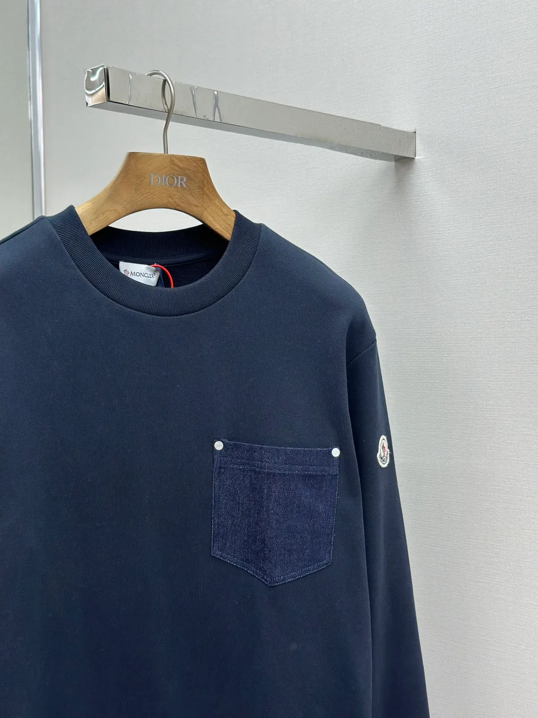 P320 Moncler denim pocket sweatshirt. Customized cotton soft velvet and cloud yarn water-brushed denim. Excellent texture, comfortable and close to the skin. The rich navy blue is the main color, showing an elegant gentleman's style. The unique denim chest pocket on the chest adds a touch of uninhibited casualness with the unique ruggedness and retro of denim. The iconic Moncler embroidered logo appears on the sleeves. It is highly recognizable and exudes a sense of luxury from the inside out. Find the perfect balance between simplicity and sophistication. Process 1: Hidden seamless hemming. Use precise laser cutting to cut the edges of the pocket into the required denim shape to ensure neat and precise edges. Then use one-piece molding technology to perfectly combine the denim material with the pocket to achieve a seamless connection. Process 2: Manual nailing using a servo motor-driven nailing device to accurately drive the bottom nails into the splicing of denim and sweatshirt velvet. Precise positioning to keep the edges of the pockets flat. Process 3: The fabrics have been washed, giving a better hand feel and not easy to deform. Not easy to shrink, not easy to fade, maintain long-term beauty Accessories: Customized Moncler embroidered logo Customized Moncler bottom nails Customized Moncler trademark Version: Loose version Size: S M L XL Style number: 25338-A75