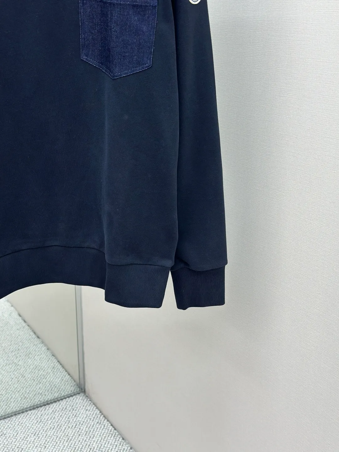 P320 Moncler denim pocket sweatshirt. Customized cotton soft velvet and cloud yarn water-brushed denim. Excellent texture, comfortable and close to the skin. The rich navy blue is the main color, showing an elegant gentleman's style. The unique denim chest pocket on the chest adds a touch of uninhibited casualness with the unique ruggedness and retro of denim. The iconic Moncler embroidered logo appears on the sleeves. It is highly recognizable and exudes a sense of luxury from the inside out. Find the perfect balance between simplicity and sophistication. Process 1: Hidden seamless hemming. Use precise laser cutting to cut the edges of the pocket into the required denim shape to ensure neat and precise edges. Then use one-piece molding technology to perfectly combine the denim material with the pocket to achieve a seamless connection. Process 2: Manual nailing using a servo motor-driven nailing device to accurately drive the bottom nails into the splicing of denim and sweatshirt velvet. Precise positioning to keep the edges of the pockets flat. Process 3: The fabrics have been washed, giving a better hand feel and not easy to deform. Not easy to shrink, not easy to fade, maintain long-term beauty Accessories: Customized Moncler embroidered logo Customized Moncler bottom nails Customized Moncler trademark Version: Loose version Size: S M L XL Style number: 25338-A75