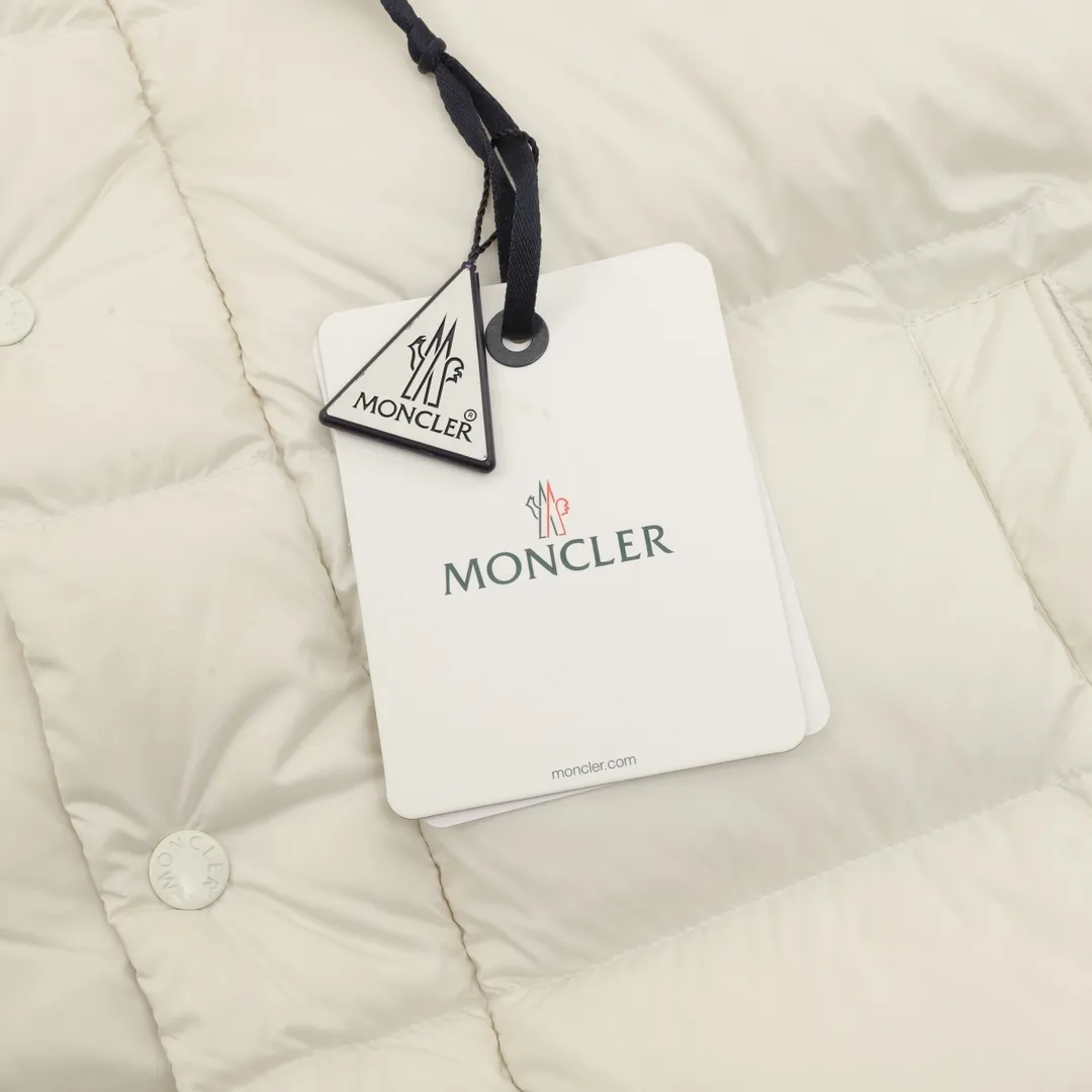P1420 Moncler/Mask Maya matte down jacket This Vezere short down jacket is a basic warm item that highlights Moncler’s style characteristics. The Vezere down jacket is made from longue saison fabric, which is both lightweight and warm. This short down jacket features a hood that can be easily removed depending on the weather. The jacket's silhouette and sleeve patch pockets pay homage to the iconic Moncler Maya down jacket. ·Made of longue saison fabric·Nylon lé ger brillant lining filled with 90% goose down Detachable and adjustable hood with zipper and snap-button closure zippered pockets Patch pockets on sleeves·Adjustable cuffs·Drawstring hem Unisex Size: 1-5