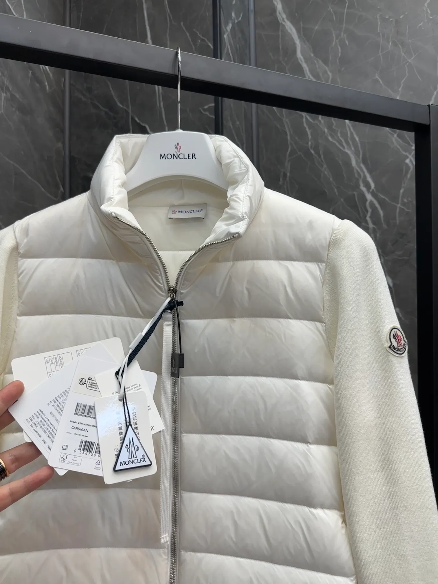 P660 New in Down⬆️Moncler Cardigan Women's Lightly Padded Wool Down Cardigan Jacket. This women's wool cardigan is filled with down and is suitable for all seasons.  This cardigan is a classic Moncler design that can be worn on its own when the weather is nice, or paired with jackets and coats when the weather cools down. Wool knit style with down-filled front for warmth and protection. Details Made of fine wool and nylon léger brillant •Nylon léger brillant lining •Down filling •Jersey knit •14 gauge •Zip closure •Zip pockets Size : 1-3 Black White