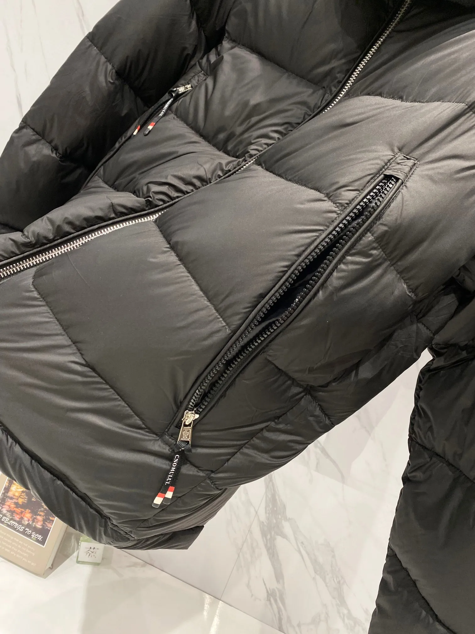 P720 Moncler｜Moncler Moncler 2025 Autumn and Winter New Down Jacket Couple’s Popular Down Jacket ▪️Filling The filling is the new national standard 80 pure white duck down! 700 fill power! Huge fluffy! Easily survive the winter in one piece in the north! Four layers of 400D film-coated bile cloth on the front and back! Rest assured that after washing and wearing it for several years, the lint will not get lost!  ▪️Hardware accessories, original disassembly, mold opening and custom-made four-button buckles, zipper pullers, all with the same LOGO and engraving as the original! Tags, hanging beads, washing, stickers, all original details restored! Really high quality!  Color: Black Size: M L XL