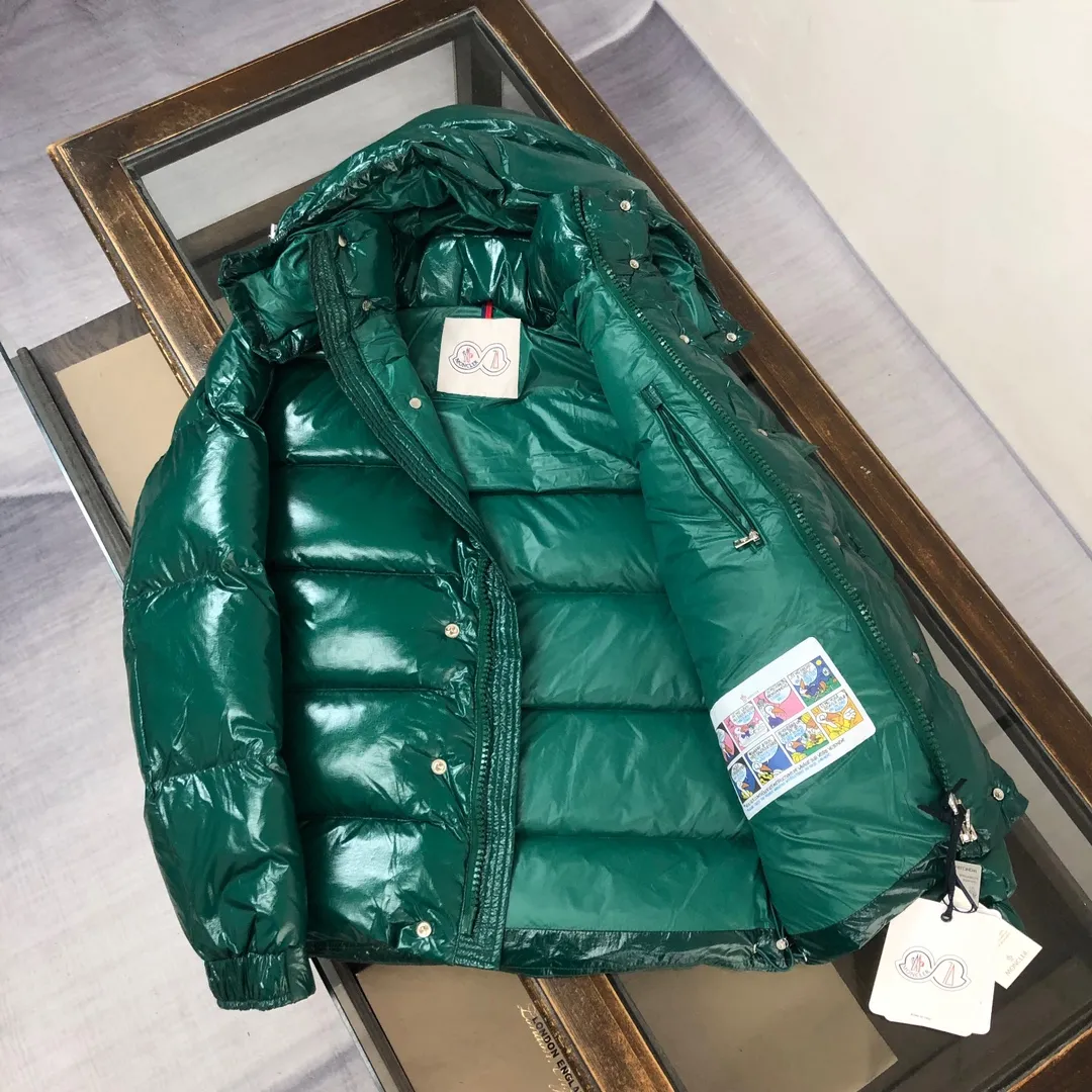 P800 Moncler Maya 70 Short Down Jacket Forest Green The iconic men's Moncler Maya 70 down jacket is highly recognizable and specially designed to celebrate the brand's 70th anniversary. The Moncler Maya down jacket has been reinterpreted specifically to celebrate Moncler's 70th anniversary, and the iconic silhouette has been refreshed in new colors. A classic example of the brand's DNA, it's made from shiny lacquered nylon and embellished with signature rectangular quilting. A classic, cropped design that spans seasons and fashions, the removable hood features a statement silhouette, removable hood and adjustable hem. The sleeves are decorated with the brand's signature classic patch pockets and a patchwork logo designed to celebrate the 70th anniversary. Color: black, ivory white, basalt gray, purple, cabin brown, forest green, code number: 1-2-3-4-5 (M～3xl)