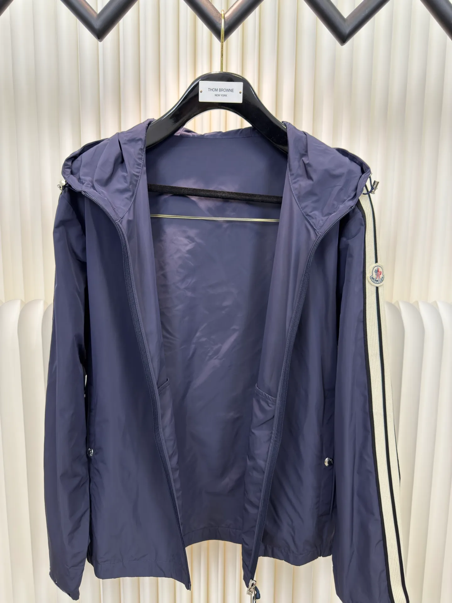 P570 MONCLER lightweight jacket with web trim at the mouth is made of 100% polyester fiber to create a tough protective outer layer. It is famous for its excellent tear resistance and wear resistance. It can quickly return to flatness during wearing and maintain the crisp and stylish appearance of the clothing for a long time. At the same time, it is not easy to deform after being washed for a long time.  Decorative edging in two different colors has been added to the center section of the sleeves. This design element not only adds visual highlights to clothing, making it more fashionable and unique. The webbing is precisely positioned along the cuffs to the seam of the collar and hat to ensure symmetry and overall smoothness. Before actual sewing, use very fine basting stitches for pre-fixing. This step is crucial to prevent the webbing from slipping, twisting, or wrinkling during sewing and ensuring that the final stitch is straight and perfect. Size 1 2 3 4