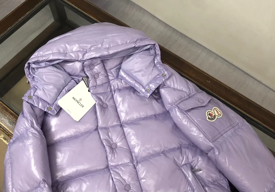 P800 Moncler Maya 70 short down jacket, lavender. The iconic men's Moncler Maya 70 down jacket is highly recognizable and specially designed to celebrate the brand's 70th anniversary. The Moncler Maya down jacket has been reinterpreted specifically to celebrate Moncler's 70th anniversary, and the iconic silhouette has been refreshed in new colors. A classic example of the brand's DNA, it's made from shiny lacquered nylon and embellished with signature rectangular quilting. A classic, cropped design that spans seasons and fashions, the removable hood features a statement silhouette, removable hood and adjustable hem. The sleeves are decorated with the brand's signature classic patch pockets and a patchwork logo designed to celebrate the 70th anniversary. Color: black, ivory white, basalt gray, purple, cabin brown, forest green, code number: 1-2-3-4-5 (M～3xl)