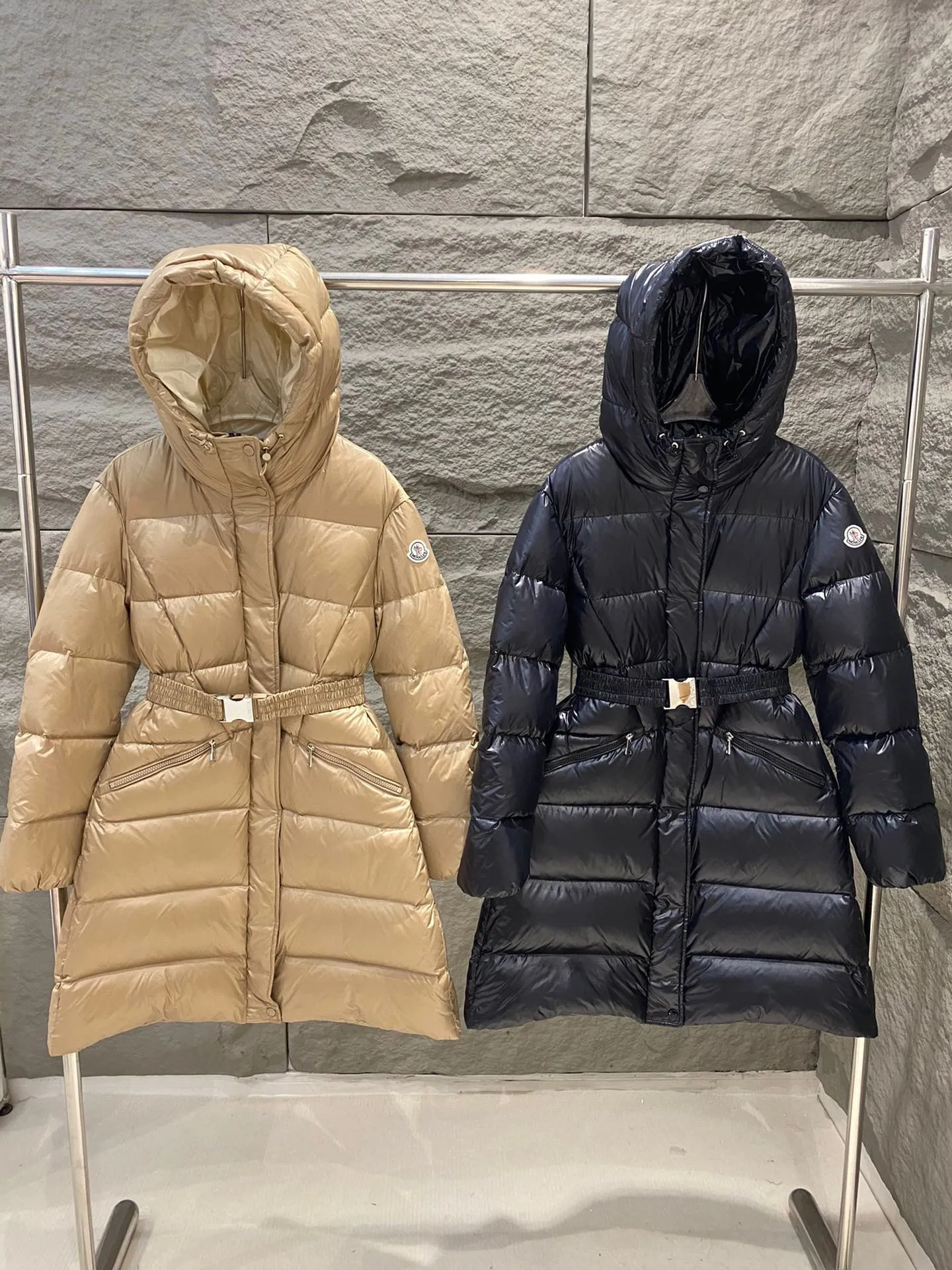 P1180 Moncler Bellevue Women's Long Belted Down Jacket The Bellevue down jacket is made of iconic nylon laqué fabric, interpreting classic Moncler style. Long design, the fabric has been functionally treated for a gorgeous lustrous effect. This hooded thermal piece has a feminine silhouette and an elastic waistband. From day to night, from the city to the mountains, it can be easily handled. Color: black/khaki Size: 0/1/2/3
