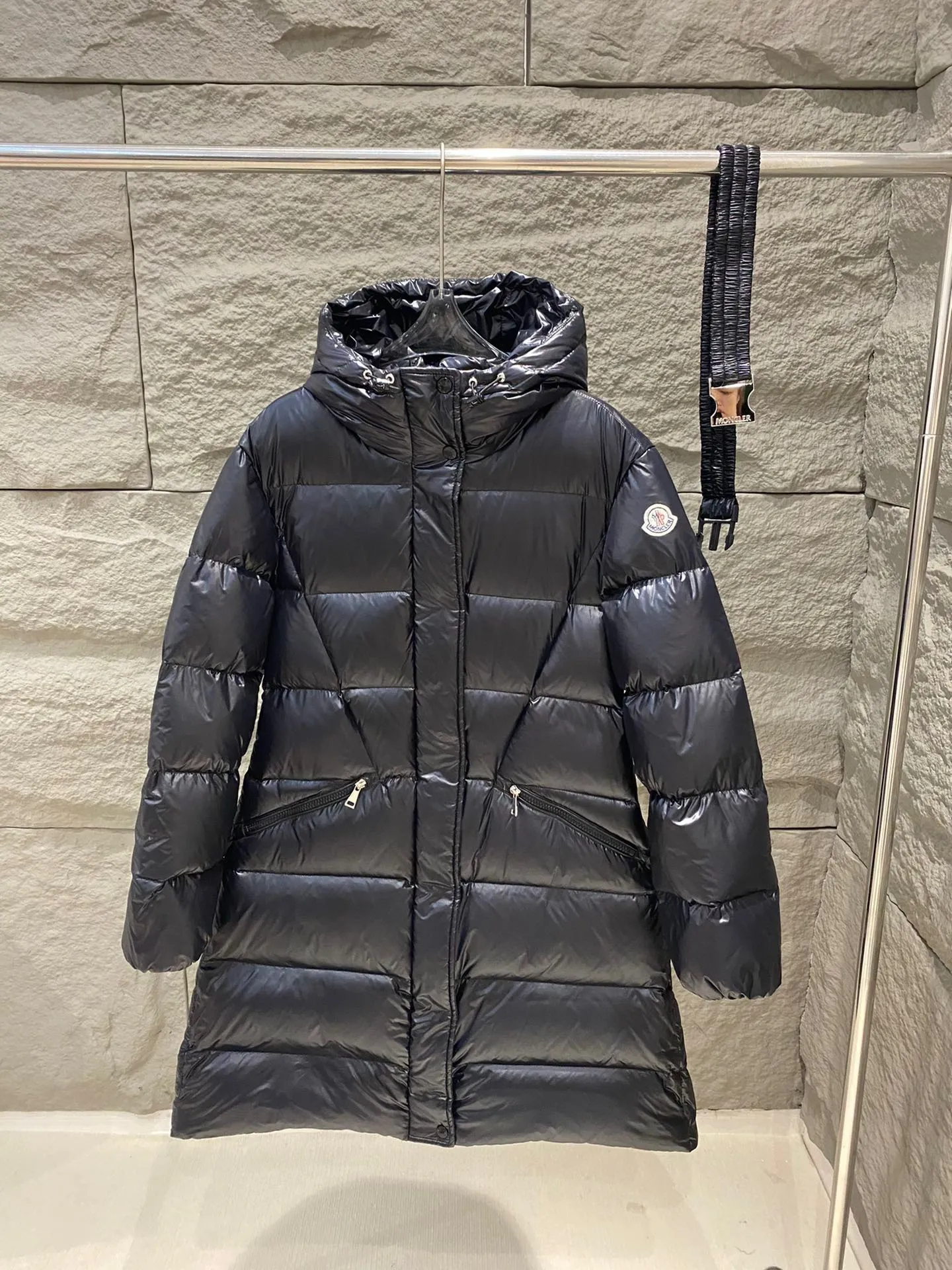 P1180 Moncler Bellevue Women's Long Belted Down Jacket The Bellevue down jacket is made of iconic nylon laqué fabric, interpreting classic Moncler style. Long design, the fabric has been functionally treated for a gorgeous lustrous effect. This hooded thermal piece has a feminine silhouette and an elastic waistband. From day to night, from the city to the mountains, it can be easily handled. Color: black/khaki Size: 0/1/2/3