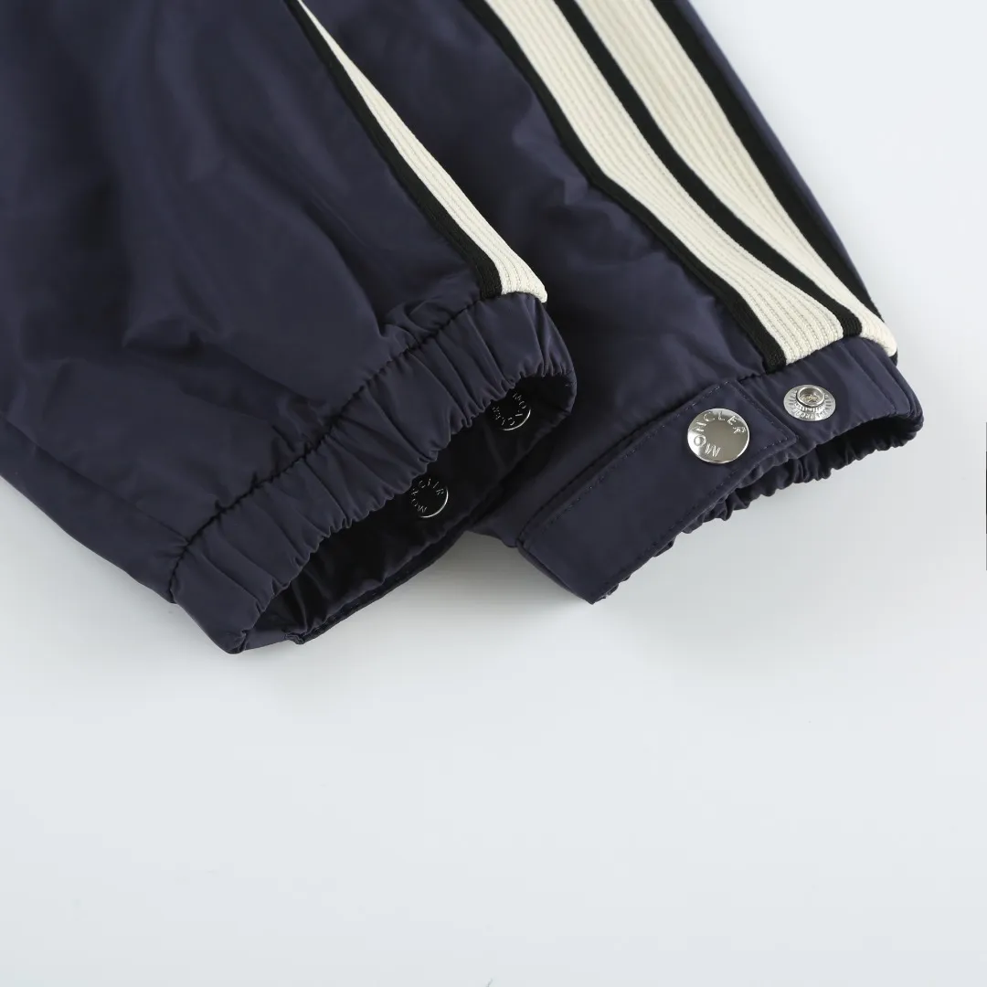 P540 MONCLER web-trimmed lightweight jacket Fabric selection: 100% polyester fiber is used to create a tough protective outer layer. It is known for its excellent tear resistance and wear resistance. It can quickly return to flatness during wearing and maintain the crisp and stylish appearance of the clothing for a long time. At the same time, it is not easy to deform after being washed for a long time.   Features: Two different colored decorative strips added to the center part of the sleeves. This design element can not only add visual highlights to clothing, making it more fashionable and unique. Craftsmanship: The webbing is precisely positioned along the cuffs to the seam of the collar and hat to ensure symmetry and overall smoothness. Before actual sewing, use very fine basting stitches for pre-fixing. This step is crucial to prevent the webbing from slipping, twisting, or wrinkling during sewing and ensuring that the final stitch is straight and perfect.  Accessories: 1:1 customized zipper puller, 1:1 customized buttons with logo, 1:1 customized hood drawstring elastic buckle SIZE: 1 2 3 4