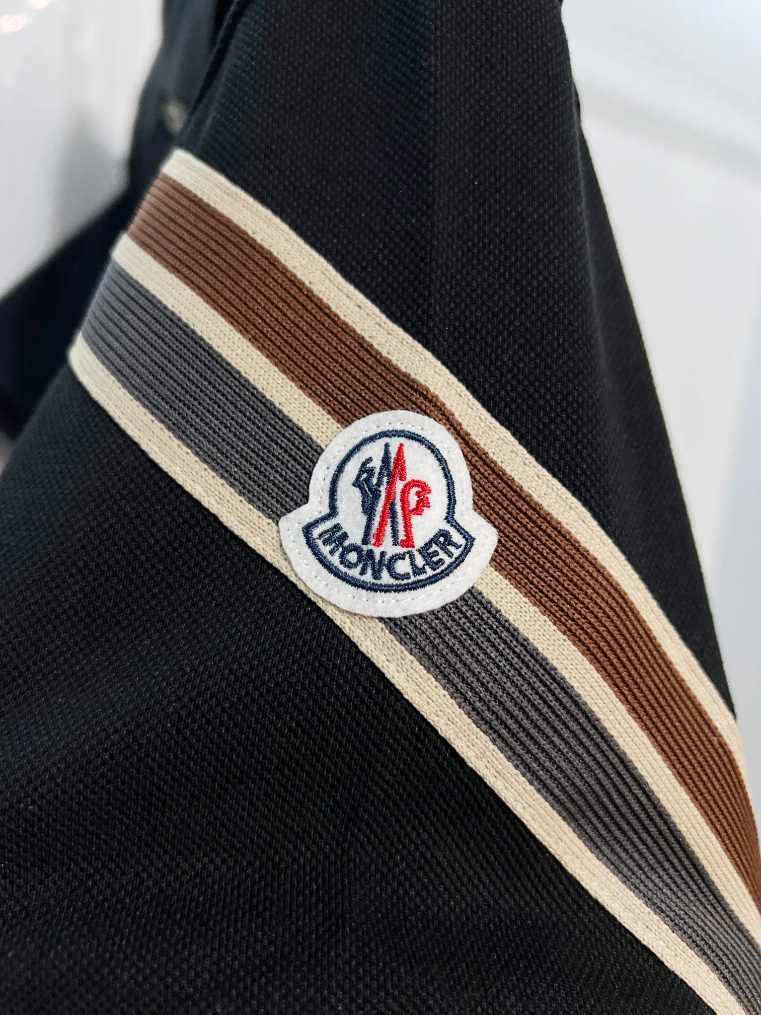 P180 MONCLER/muzzle casual short-sleeved lapel polo shirt, brand classic, simple, contrasting color stripes on the sleeves, small badge letter LOGO, same style for men and women, 2026ss new early spring official synchronization, high version, high quality, fashionable personality, versatile trend, pure original quality, custom pique fabric, tag, collar label, washed wheat, three labels complete, color: black, white. Size: S M L XL XXL
