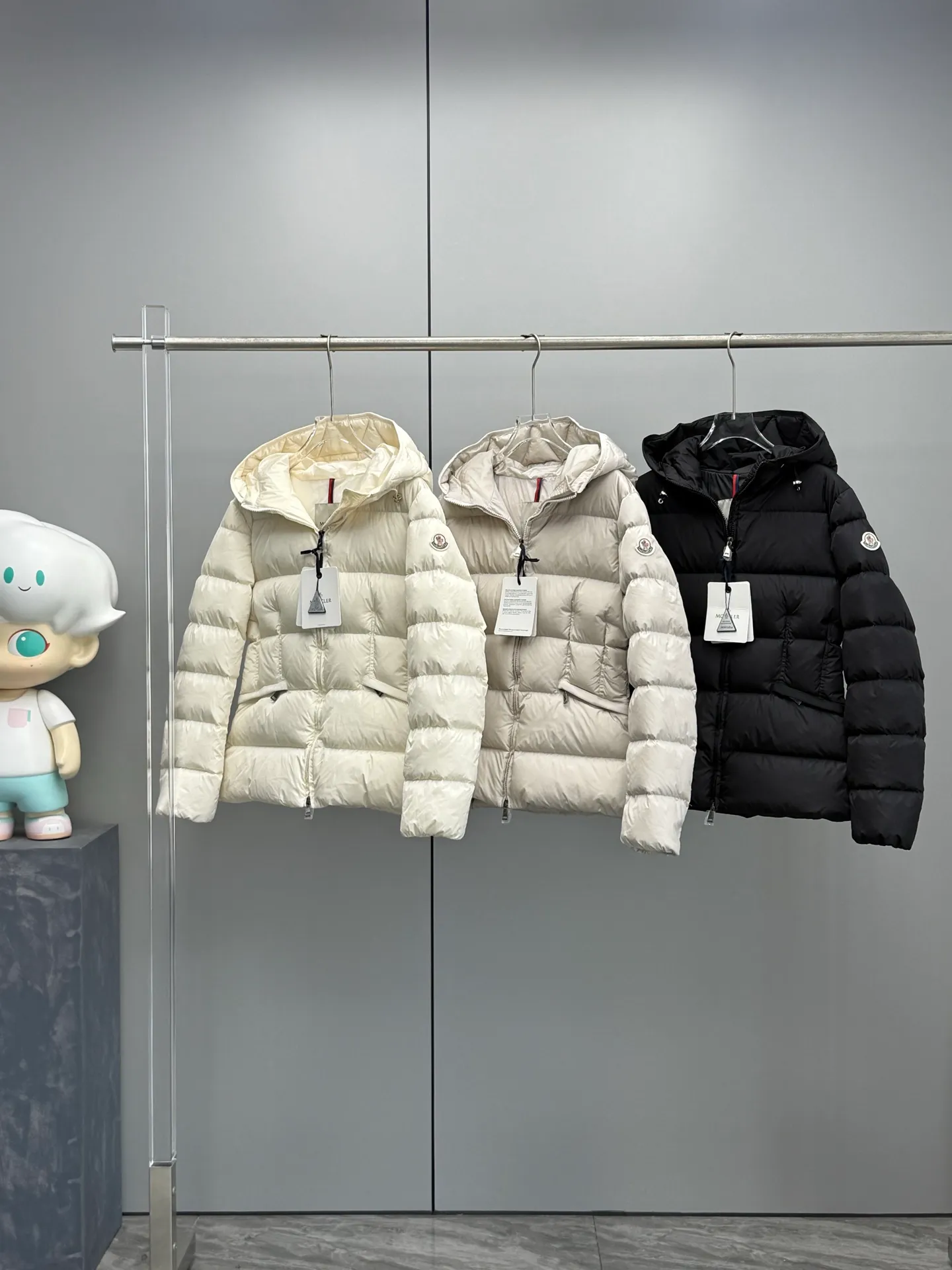 P980 Moncler 2025 Autumn and Winter New Avoce Short Women's Waist Slim Fit Adjustable Hood Down Jacket Jacket is three-dimensionally cut to reshape the elegant curves in winter and say goodbye to bloat! The ingenious three-dimensional cut and waist design outline the charming waistline in the down jacket, making it slimmer and slimmer. Whether commuting in the city or traveling on the weekend, you can always look confident and charming. Original hardware mold opening, details prove the quality. Each hardware piece is customized with original craftsmanship and mold opening, with delicate texture and durability. The zippers are smooth and the fasteners are exquisite, interpreting the attitude of high-end fashion in every detail. Light and warm, keeping out the cold without being heavy. Filled with high-quality down, which is light, soft but doubles the warmth. The short design is neat and tall. Pair it with high-waisted bottoms or boots to easily lengthen your body proportions.  Color: Black White Gray Size: 1-2-3-4