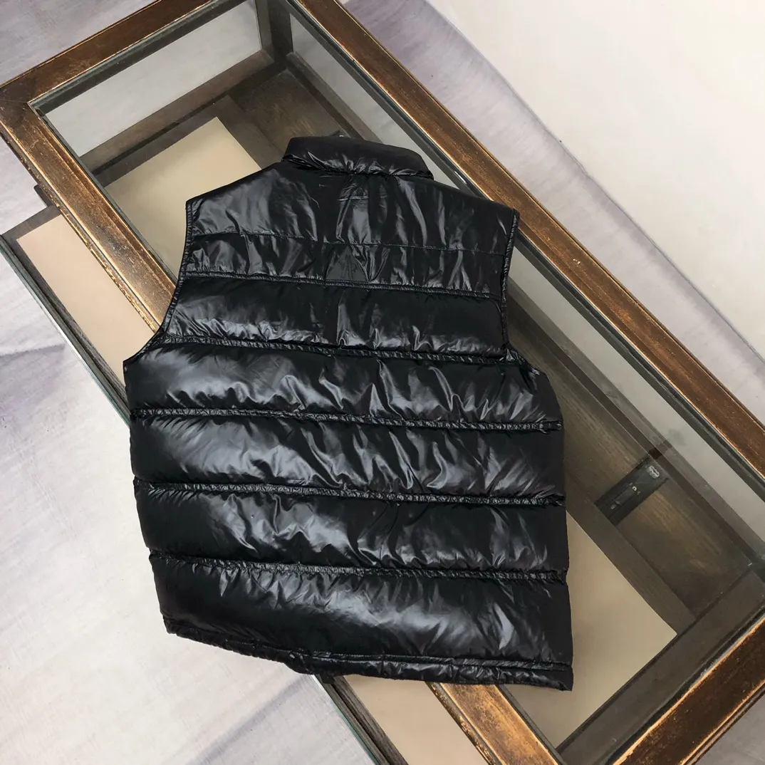P760 Moncler Men's 2025 Autumn and Winter New Nantu Ski Series Men's Stand Collar Down Vest Vest. Wear it both outside and inside. Unlock the full-scene dressing formula and refuse to be bulky. It requires warmth and style! The Nantu ski series vest is a masterstroke for layering in winter. The stand-up collar is designed to be windproof and can be paired with a sweater or sweatshirt to instantly enhance the sense of layering and give it a sporty and casual look. Inner layer: light and close-fitting, seamlessly integrated into the interior of a suit or coat, providing invisible warmth without looking bulky, and can easily cope with the temperature difference between indoors and outdoors. Designed from the professional ski line, its thermal insulation performance is unquestionable, and it can handle urban outdoor use with ease. The neat three-dimensional tailoring abandons the bulging feeling of traditional vests, and the side lines are clean and neat, creating a tall and straight figure. Color: Black Size: 0-1-2-3 (M-2XL)▪️
