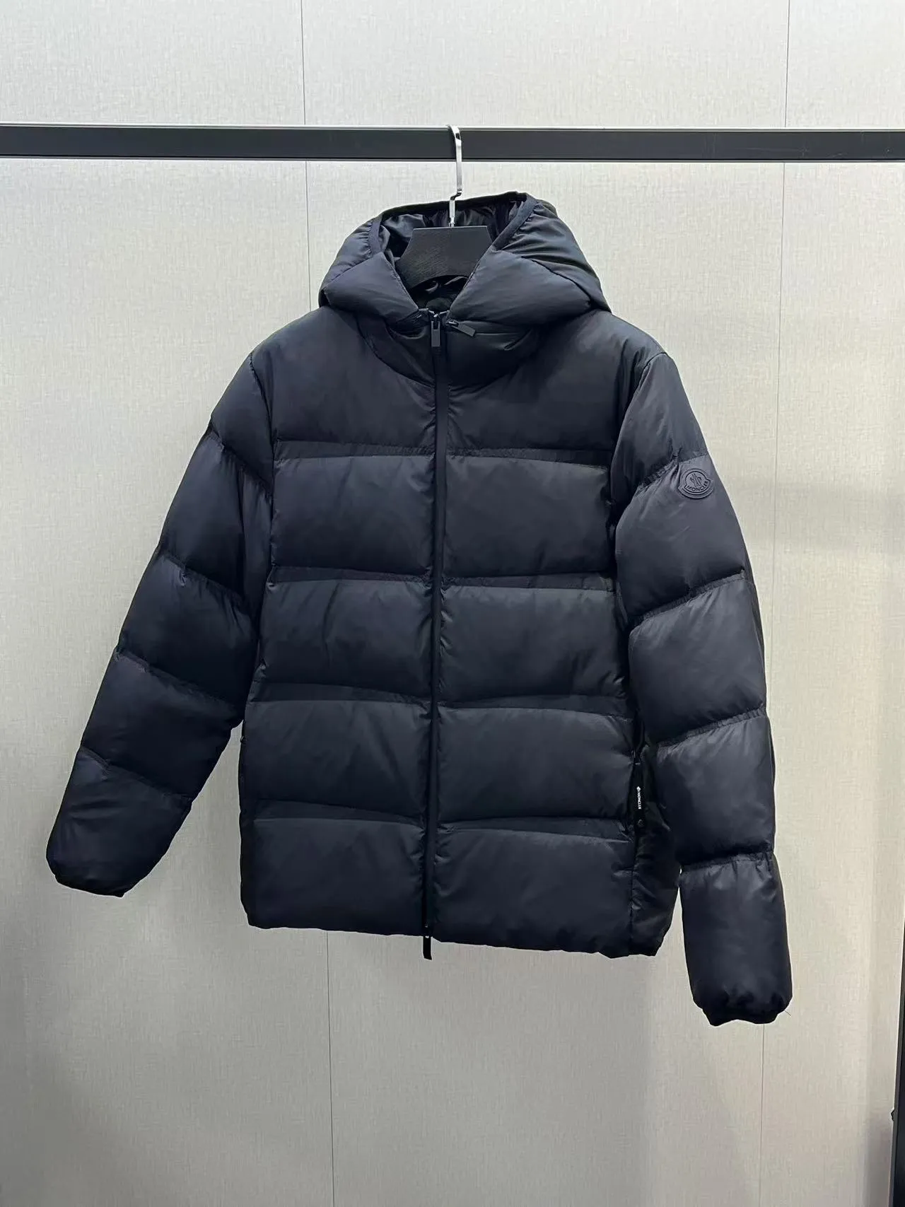 P880 special down ⬆️Moncler Masac men's short down jacket. A must-have item for fabric control. 2024 new technical fabric. Extremely lightweight. Ultra-light and ultra-white duck neck down filling. Ceiling cleanliness. 850+ fill power. ⚠️Special grade product with complete barcode numbers and consistent with the official website. The tag has built-in NFC electronic sensor anti-counterfeiting. It supports multiple anti-counterfeiting verifications. It comes standard with a full set of gift box packaging at the counter. Masac men's short down jacket is made of protective materials and decorated with geometric quilting, which is lightweight and warm.  The Masac men's down jacket combines cutting-edge fabrics with innovative details. Short design made from lightweight, fine-grained tear-resistant functional fabric for durability and practicality. Lightweight and warm, it's finished with gusseted quilting. Comes with removable hood. Details •Made from ripstop fabric •Fine soft ripstop lining •Down filled •Removable hood •Two-way zipper closure •Zip pockets •Elasticized cuffs and hem Size: 1-5 Black/Blue Couple's