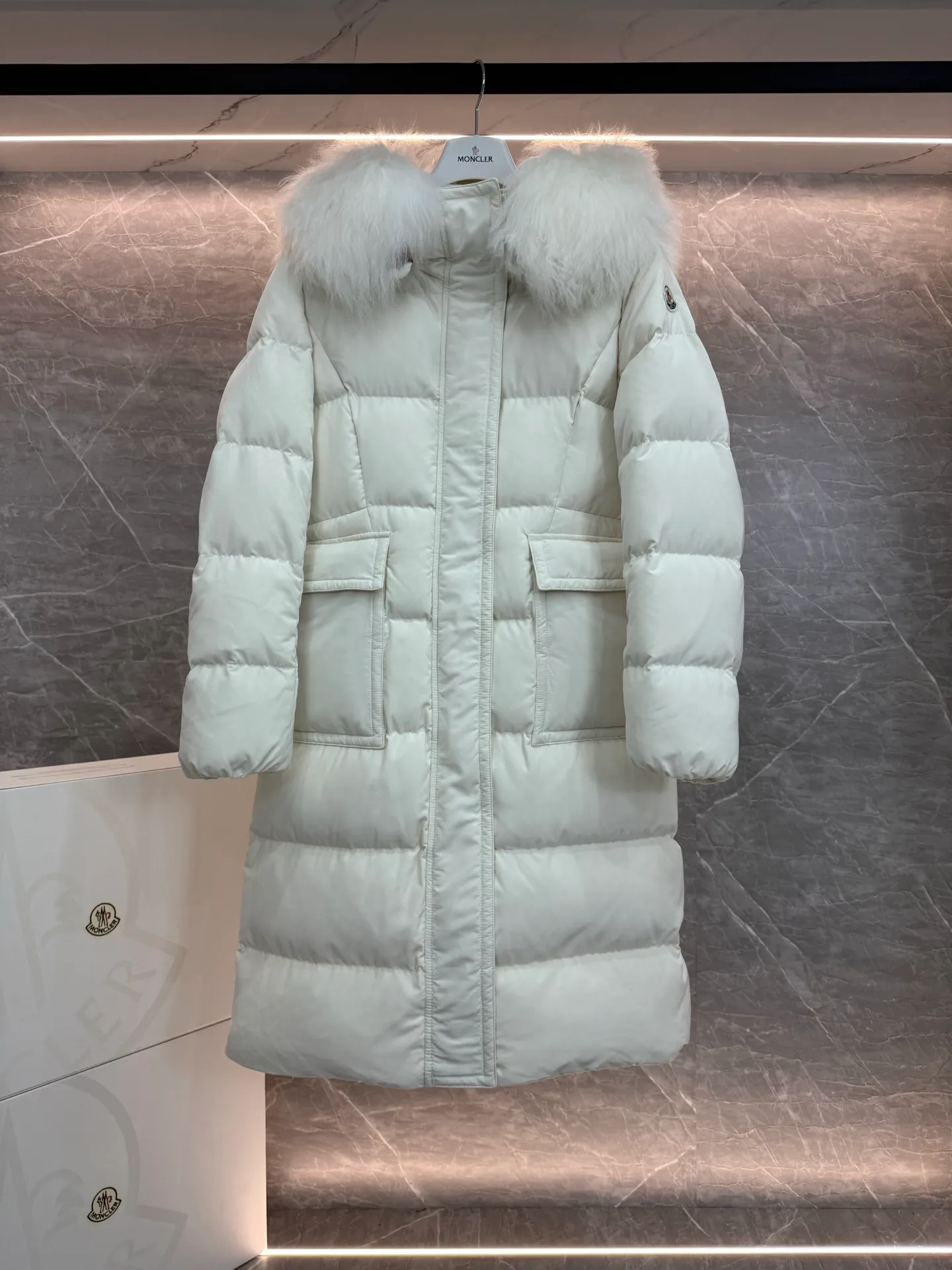 P1180 ~ New in down ⬆️Moncler* mid-length women's hooded long down jacket. The long down jacket combines exquisite materials and attention to details. The timeless and elegant fashion design can provide you with a warm and caring wearing experience. The adjustable hood embellishment, oversized wool collar, and loose fit design create a fashionable winter look. The comfortable hood is equipped with gorgeous wool decoration, full of atmosphere, and can be easily removed according to mood and weather conditions.   •Made of nylon fabric •Down filled •Hood with removable fleece collar •Two-way zipper closure •Suit pockets •Elastic cuffs Size : 0-3