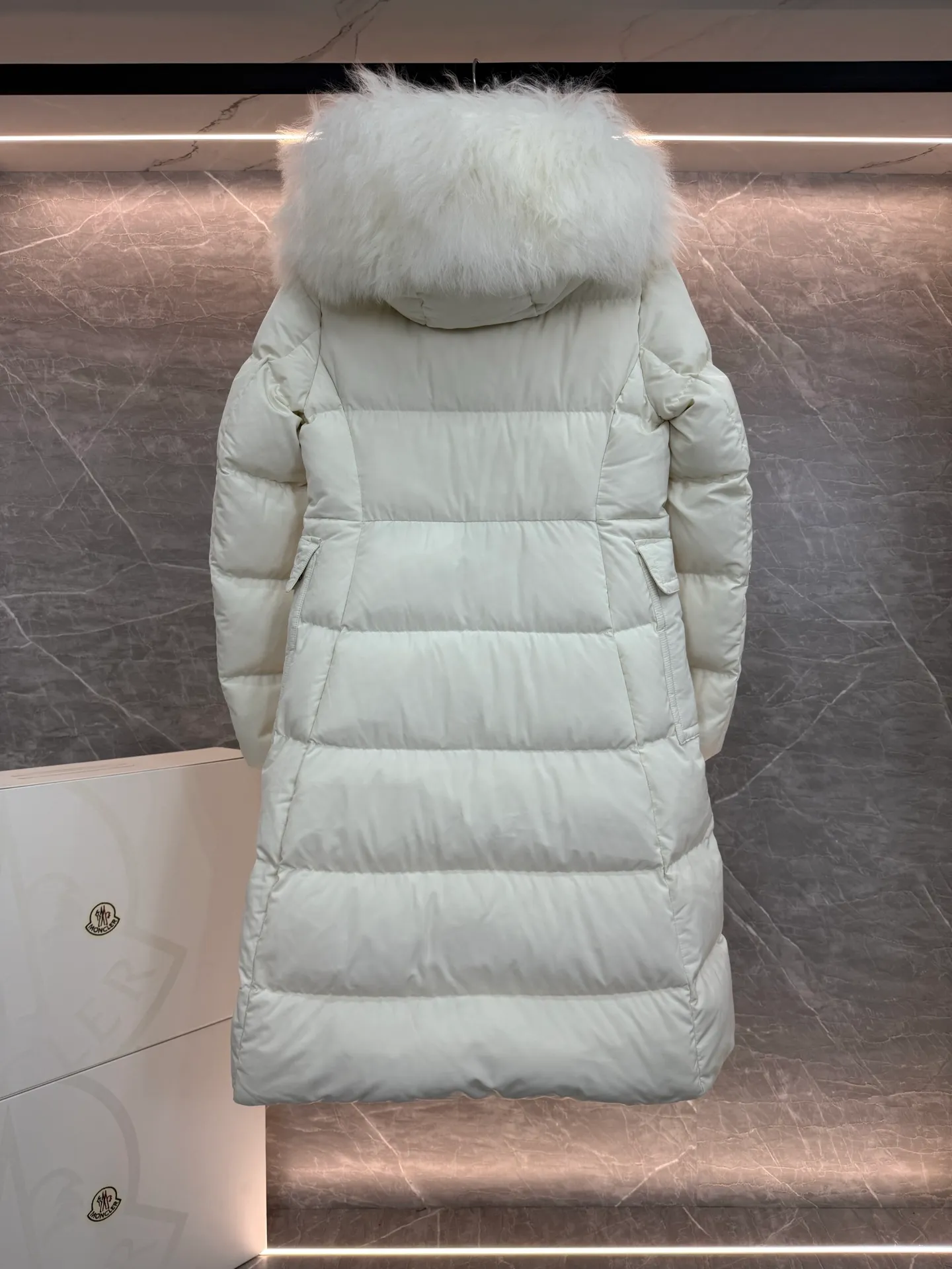 P1180 ~ New in down ⬆️Moncler* mid-length women's hooded long down jacket. The long down jacket combines exquisite materials and attention to details. The timeless and elegant fashion design can provide you with a warm and caring wearing experience. The adjustable hood embellishment, oversized wool collar, and loose fit design create a fashionable winter look. The comfortable hood is equipped with gorgeous wool decoration, full of atmosphere, and can be easily removed according to mood and weather conditions.   •Made of nylon fabric •Down filled •Hood with removable fleece collar •Two-way zipper closure •Suit pockets •Elastic cuffs Size : 0-3