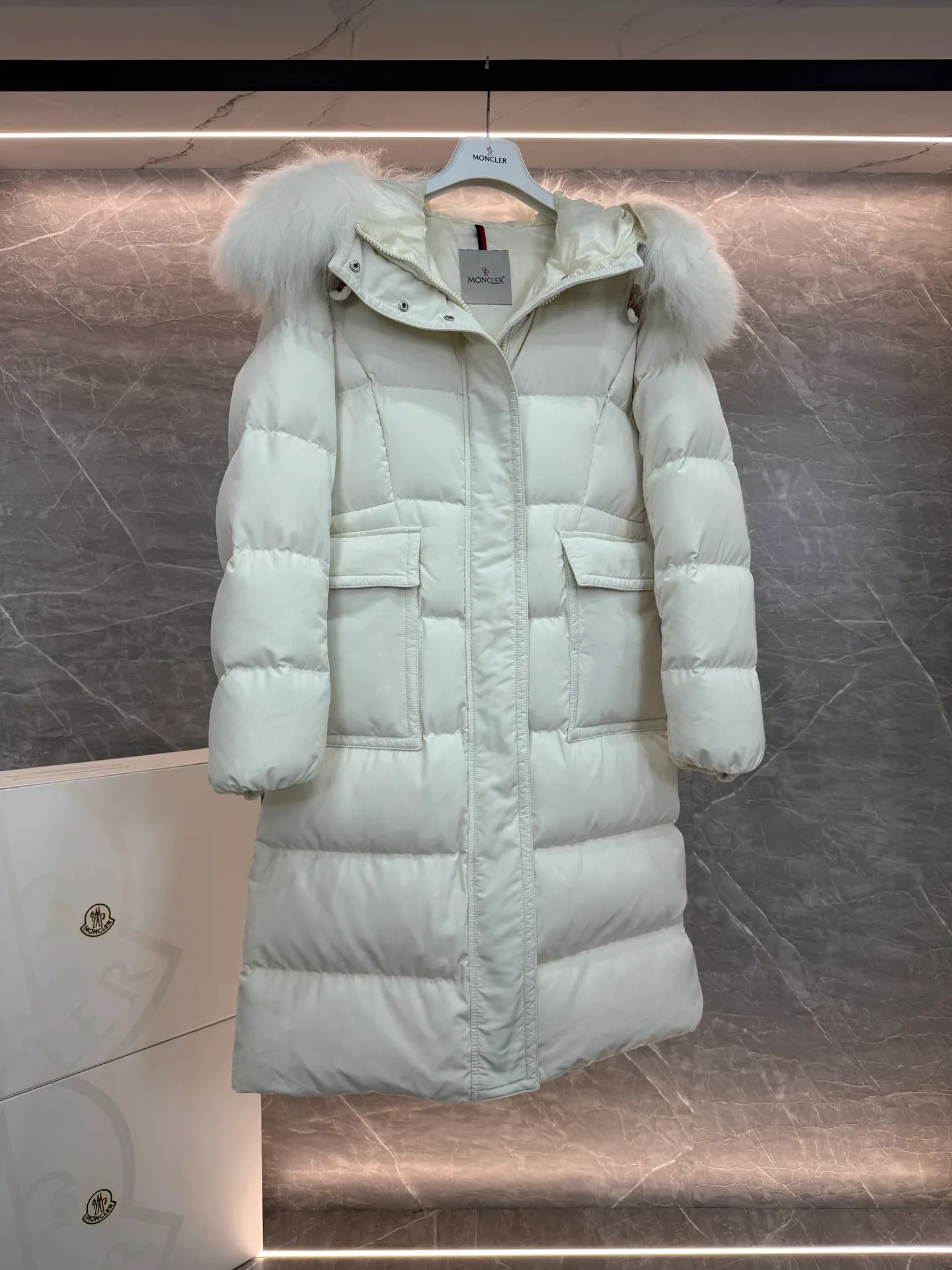 P1180 ~ New in down ⬆️Moncler* mid-length women's hooded long down jacket. The long down jacket combines exquisite materials and attention to details. The timeless and elegant fashion design can provide you with a warm and caring wearing experience. The adjustable hood embellishment, oversized wool collar, and loose fit design create a fashionable winter look. The comfortable hood is equipped with gorgeous wool decoration, full of atmosphere, and can be easily removed according to mood and weather conditions.   •Made of nylon fabric •Down filled •Hood with removable fleece collar •Two-way zipper closure •Suit pockets •Elastic cuffs Size : 0-3