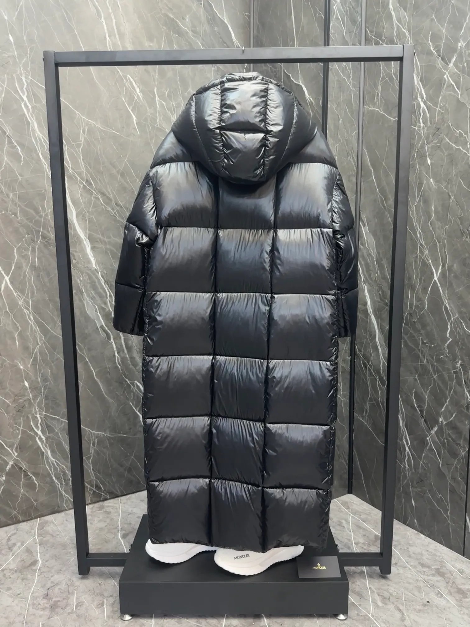 Premium down  Parnaiba's long down jacket features graphic details and bold color blocking in signature patented nylon. The eye-catching design features large grille quilting and contrasting lining. The removable hood and adjustable hem make it easy to personalize the style, and the color-blocked pattern highlights the highly recognizable Moncler vibe. Details •Made from nylon laqué fabric •Contrast nylon laqué lining •Detachable hood with zipper and drawstring •Zip closure with black patented snap fastener •Zip pocket Size: 0-4. Original runs large. D98108078950