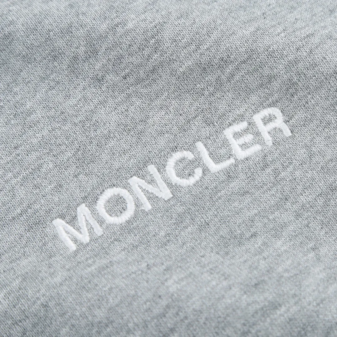 P370 MONCLER printed round neck sweatshirt Fabric selection: Single-sided fish scale fabric woven with cotton as the base. The front is a smooth knitted surface, and the skin-touching surface is formed into three-dimensional terry through the floating thread knitting technology of the knitting machine, which increases the fluffiness and has a delicate touch. The terry structure absorbs a large amount of water and evaporates quickly, so it is not easy to loosen and deform after repeated washing.  Process 1: Use glue printing to present 4 high-saturation patterns on the fabric. The pressure of the scraper is even, and the scraping printing is done in 3 times to ensure that the glue is fully penetrated and covered. After curing at high temperature, the pigment is firmly bonded to the cotton fiber. The ink-absorbing and penetrating properties of the cotton fiber make the pattern less likely to fall off due to friction.  Process 2: The 2*2 rib formed by alternating longitudinal rows of front coils and longitudinal rows of back coils is still very elastic and has a wide pattern that fits the wrist and waist without a sense of restraint. The gaps between the coils allow air to circulate without losing warmth.  Process 2: By actively interfering with the shrinkage potential of cotton fibers, the fabric is able to transition from changeable to stable, improving dimensional stability while being less prone to deformation and wrinkles.  Accessories: One to one customized 3-standard SIZE: S M L XL
