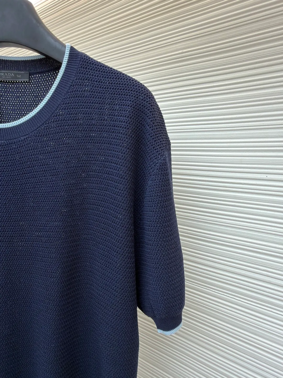 Prada letter logo sweater ●Original version: Purchased and developed for 13800 ●Item number: 1682372-A45 ●Fabric: ice silk wool fabric ●Technology: knitted production ●Color: navy blue ●Version: fitted version ●Weight: about 335 grams ●Size: 48-50-52-54 ●Description: Custom-woven, custom-dyed, luxurious and ultra-fine ice silk wool, soft and silky, comfortable and skin-friendly The main color is deep navy blue, with a touch of smart light blue edges, injecting a sense of agility. The hem of the body is embellished with the Prada letter logo, adding brand recognition. Pure lines are used to outline a simple outline, breaking the monotony in a concise way, showing a luxurious texture in a low-key manner. Imported machine embroidery technology, computer control system and precision mechanical components are used to realize the Prada logo embroidery operation with high precision and smooth and delicate lines. The curved thread structure changes the stitching and yarn arrangement during the knitting process to create a curved distribution of yarns in the fabric. The garment washing water is softened and deodorized. Professional washing equipment and specific detergents are used to deeply clean and deodorize the clothes to improve the feel and appearance of the clothes. The overall wiring is straight and delicate, the fabric is comfortable and soft, and the color is consistent without color difference. It can be matched with the same style to create a fashionable look and control various occasions. Customized accessories, complete with three standards, same style for men and women!